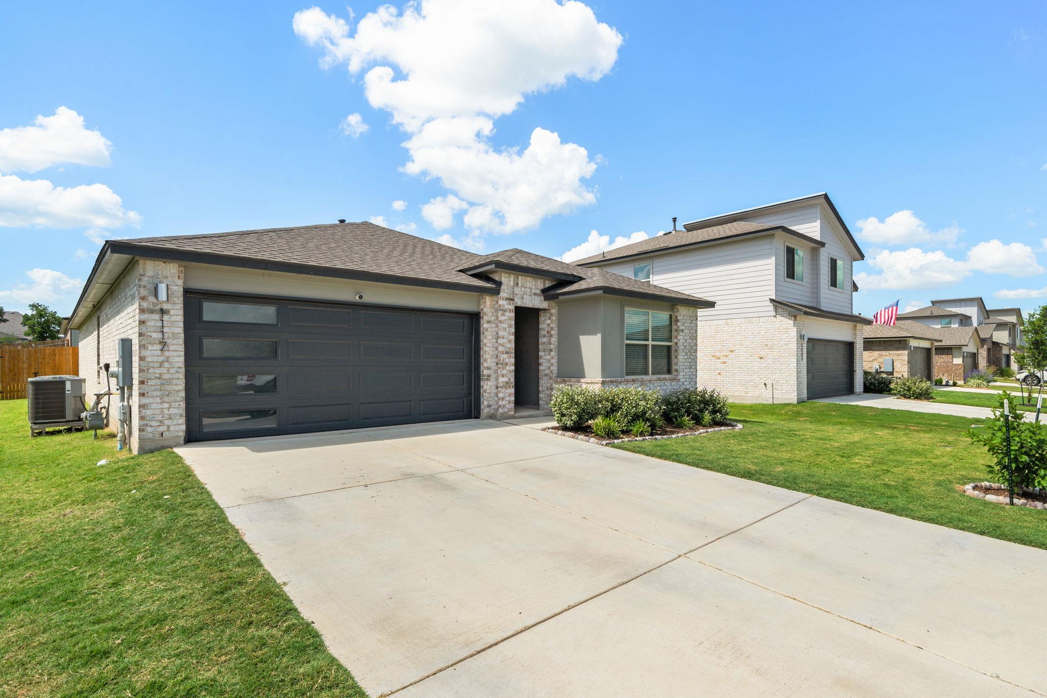 Contemporary exterior with light brick and grey s