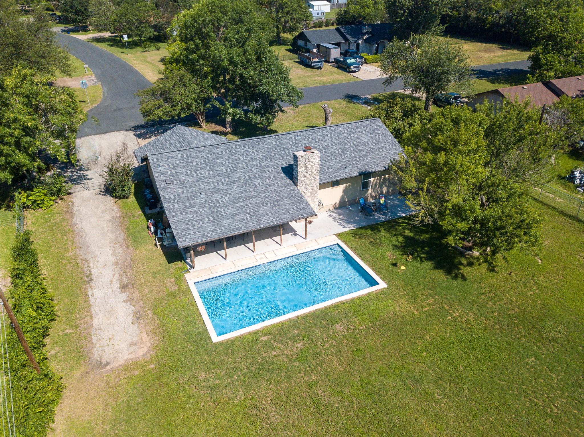 Rear exterior featuring a large rectangular swimm