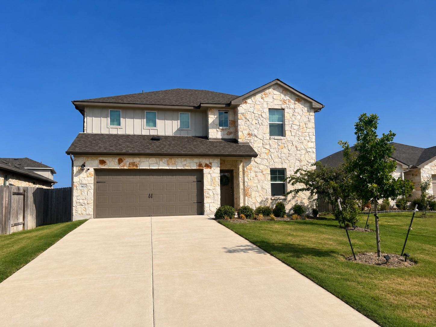 A spacious driveway leads directly to this multi-