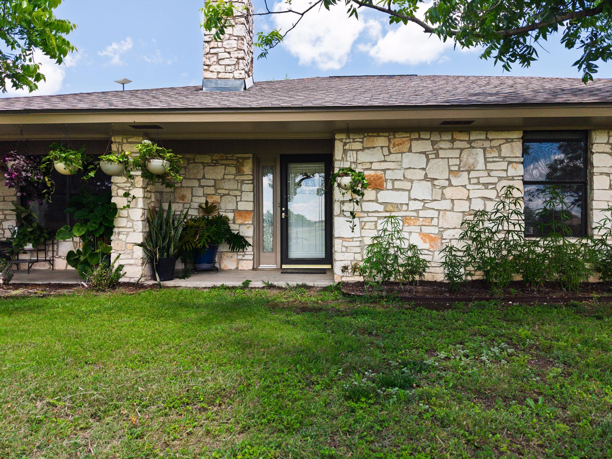 Exterior showcasing a stone facade, a brown shing