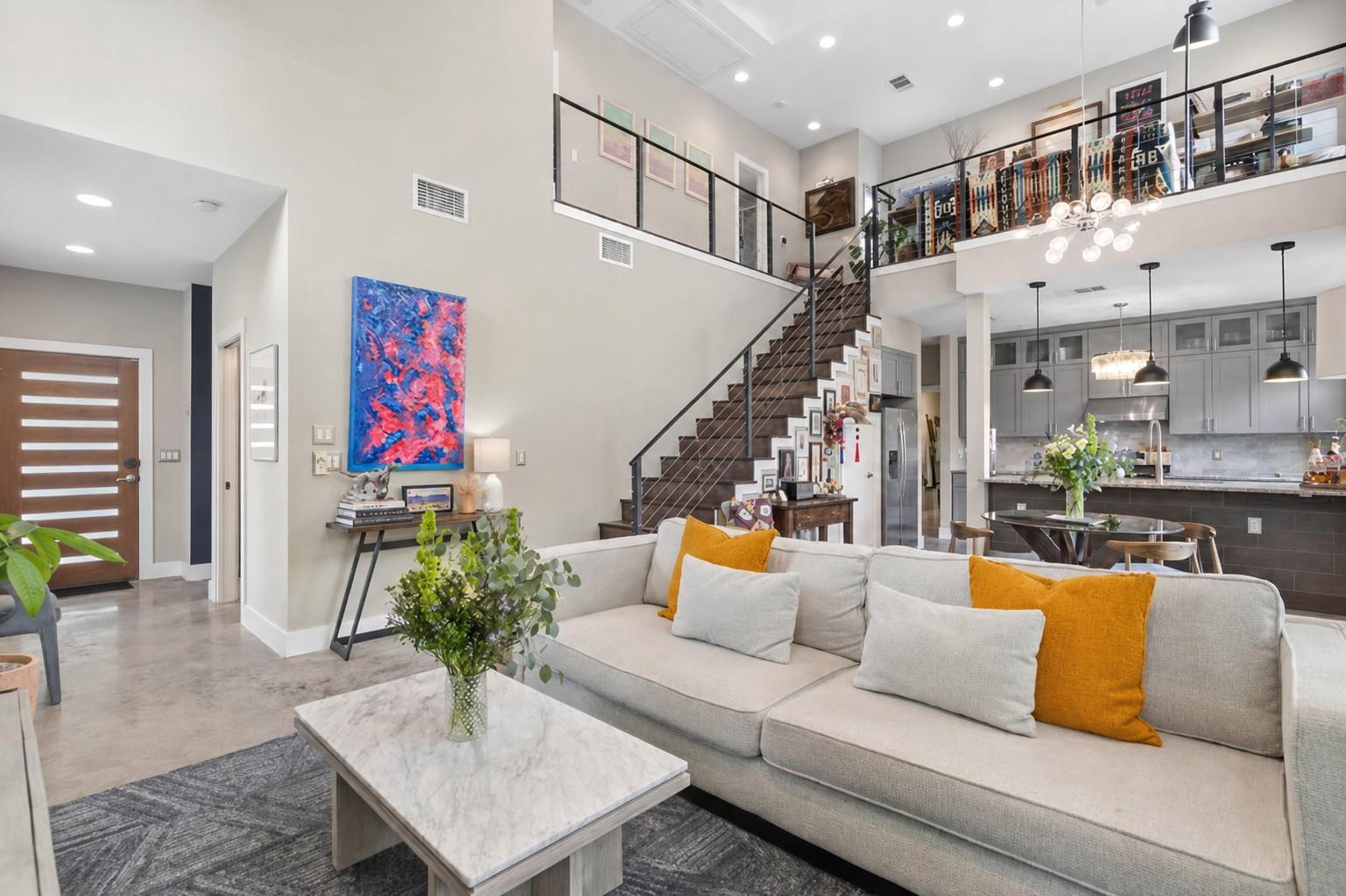 Open concept living area featuring high ceilings 