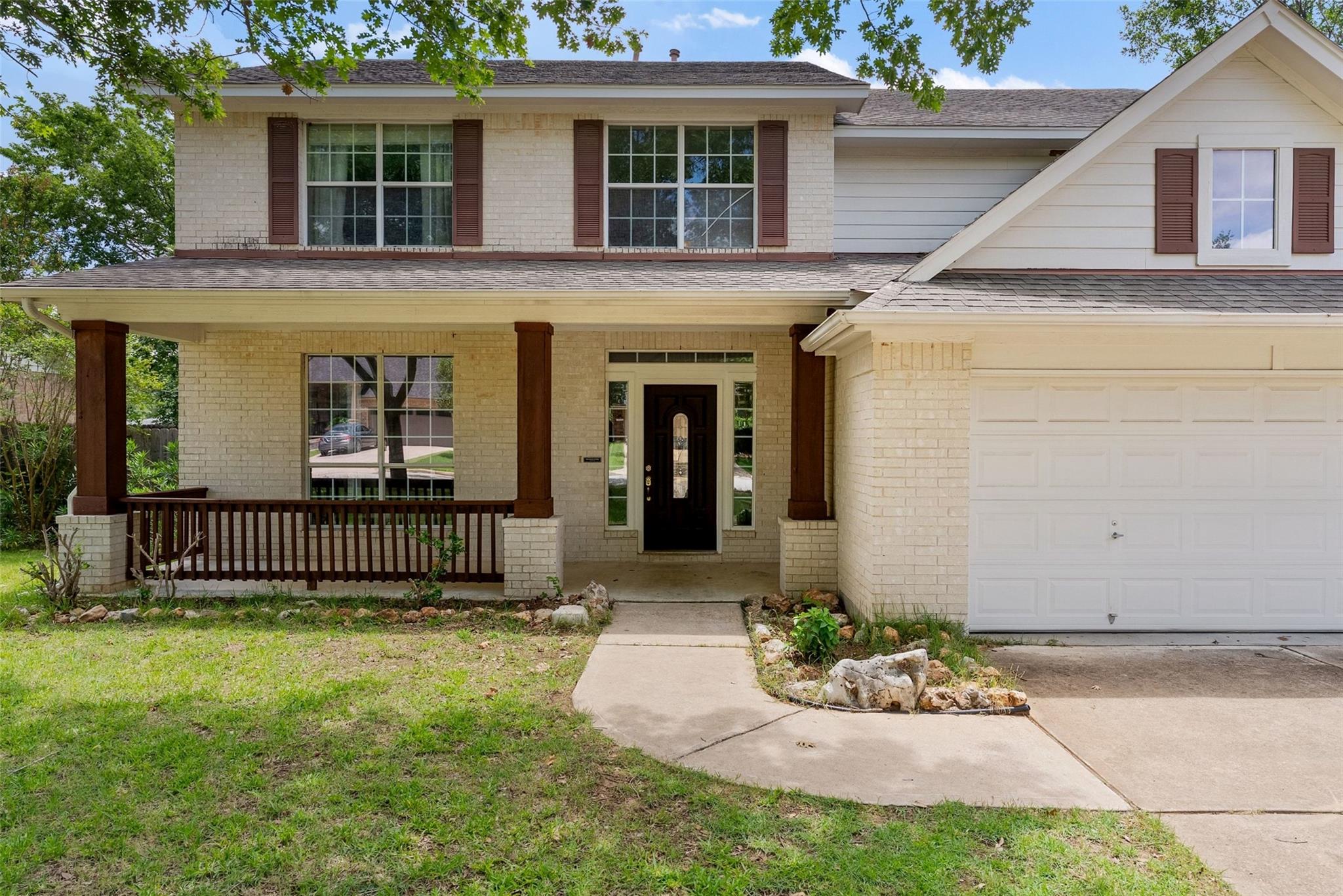 A classic brick facade welcomes with a charming c