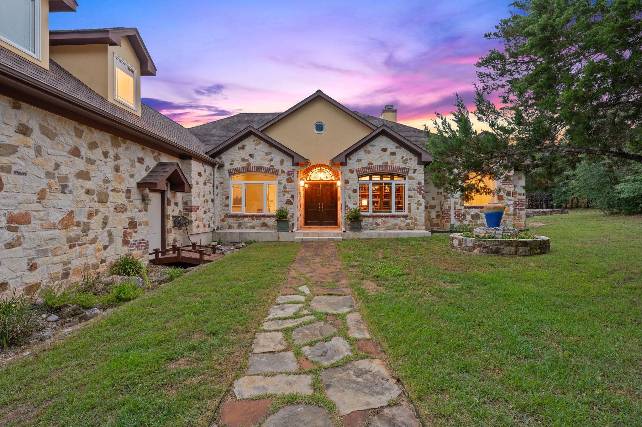 A dramatic sunset illuminates the handsome stone 