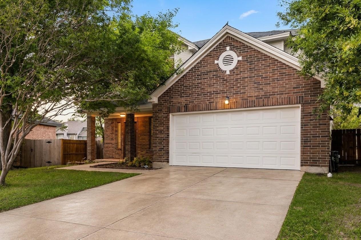 A classic brick exterior with a large garage and 