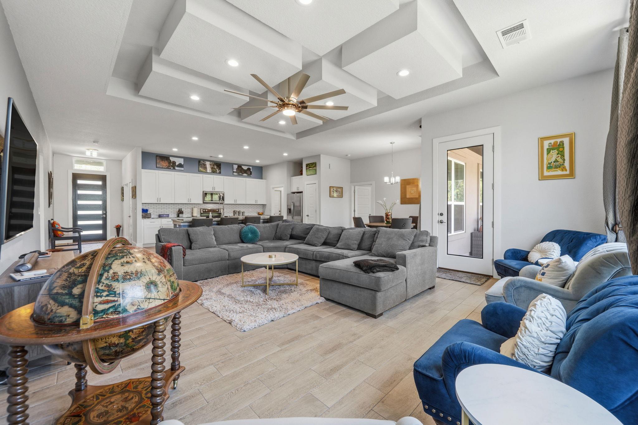 Open-concept living area featuring a multi-tiered