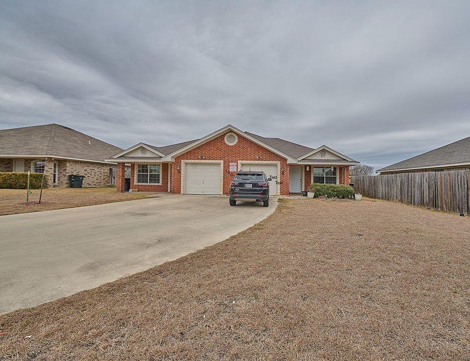 Brick exterior with a single-car garage and a con