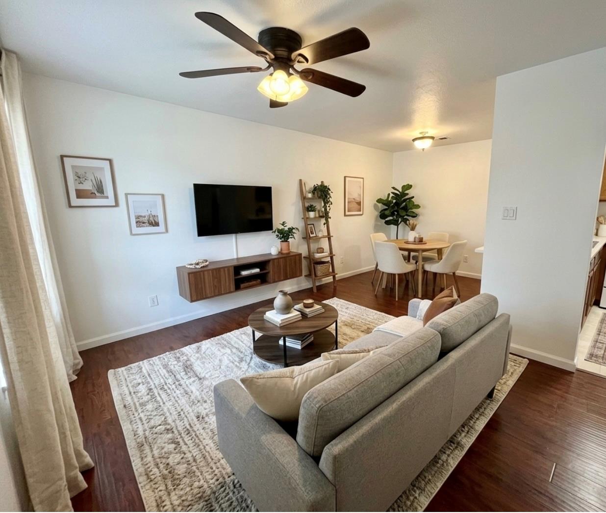 Rich wood floors extend across a versatile open l