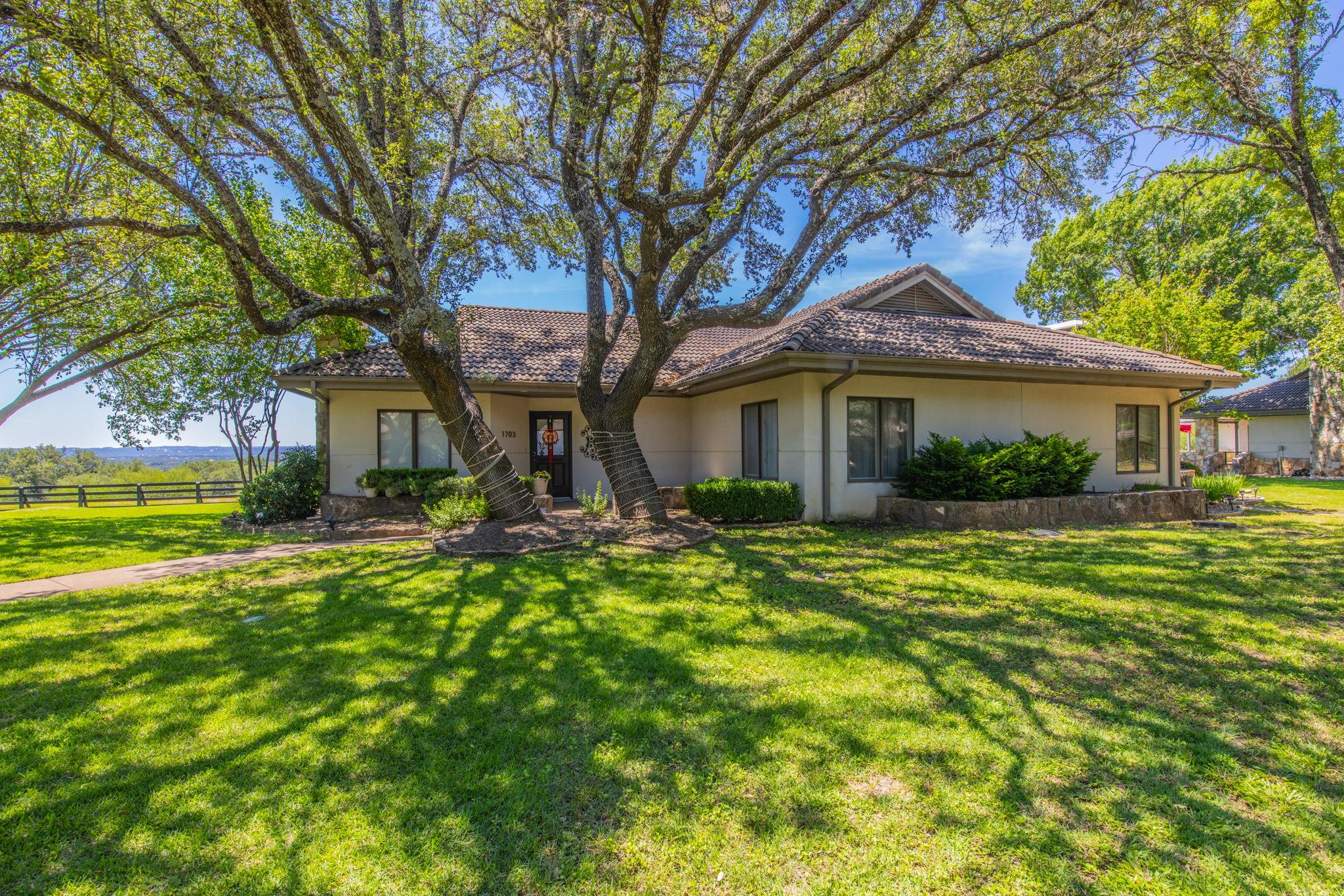 Ranch-style exterior with a tan stucco finish and