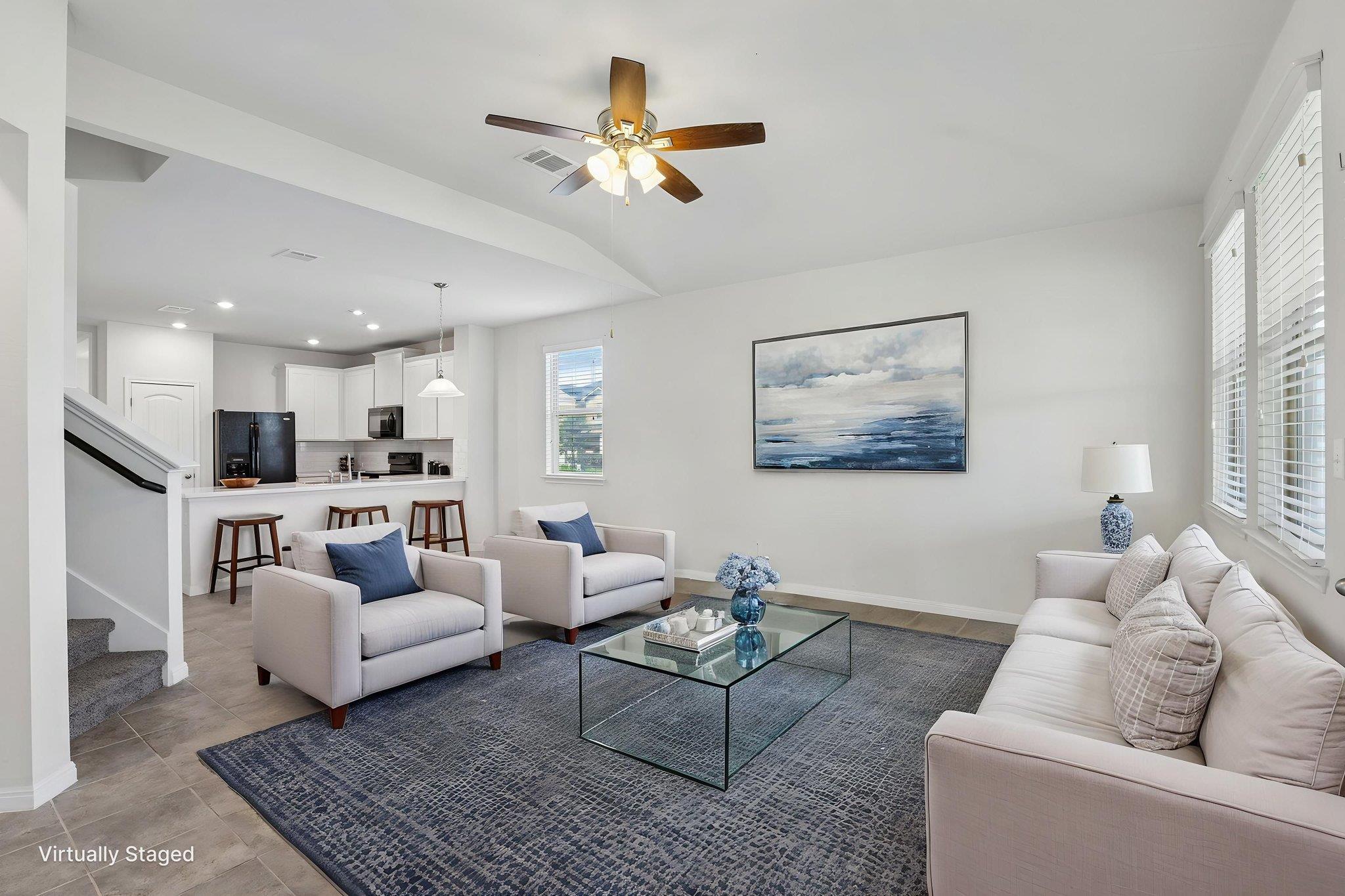 An open-concept living area boasts a modern kitch