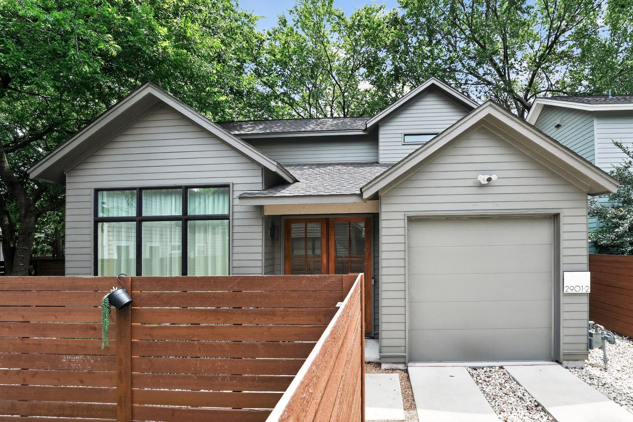 Contemporary gray siding exterior with a peaked r