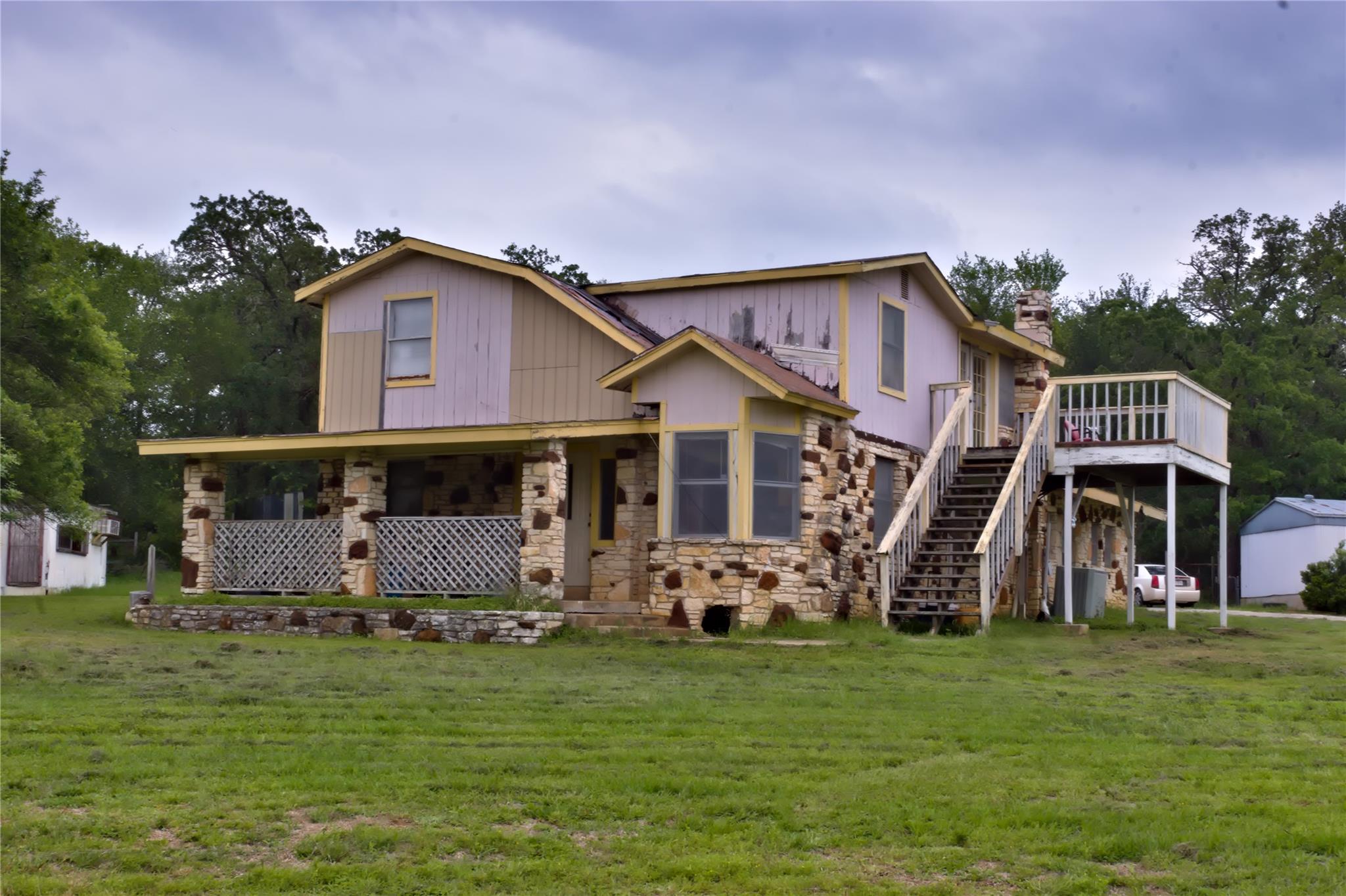 Stone and wood-sided two-story residence featurin