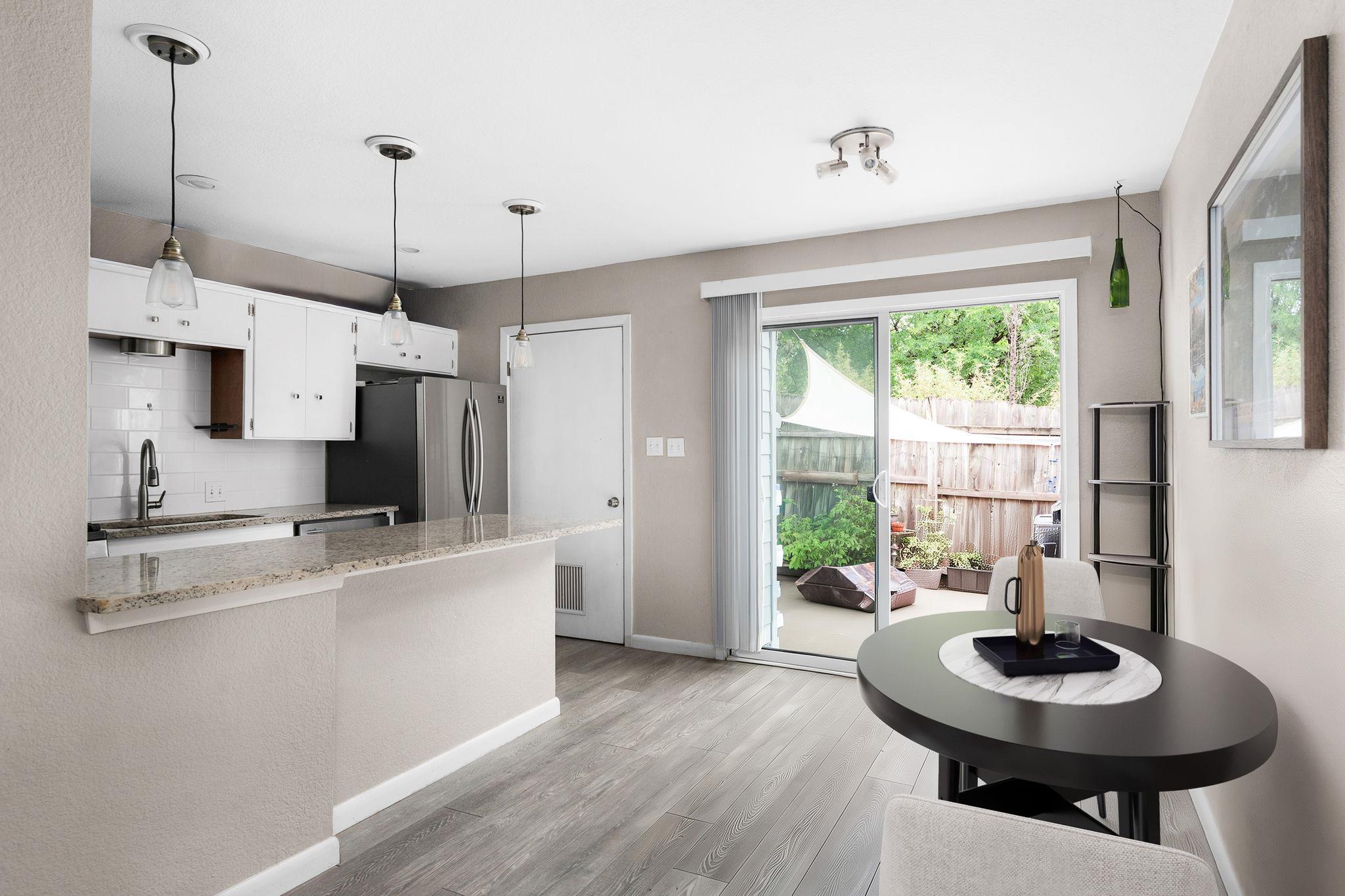 Open-concept living area featuring wood-finish fl