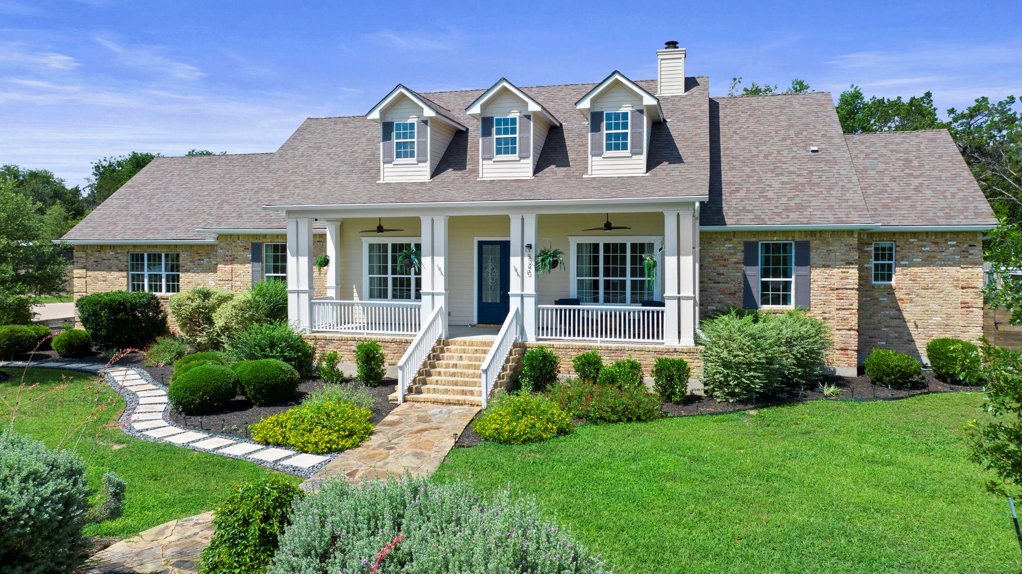 A graceful front porch welcomes you to this charm