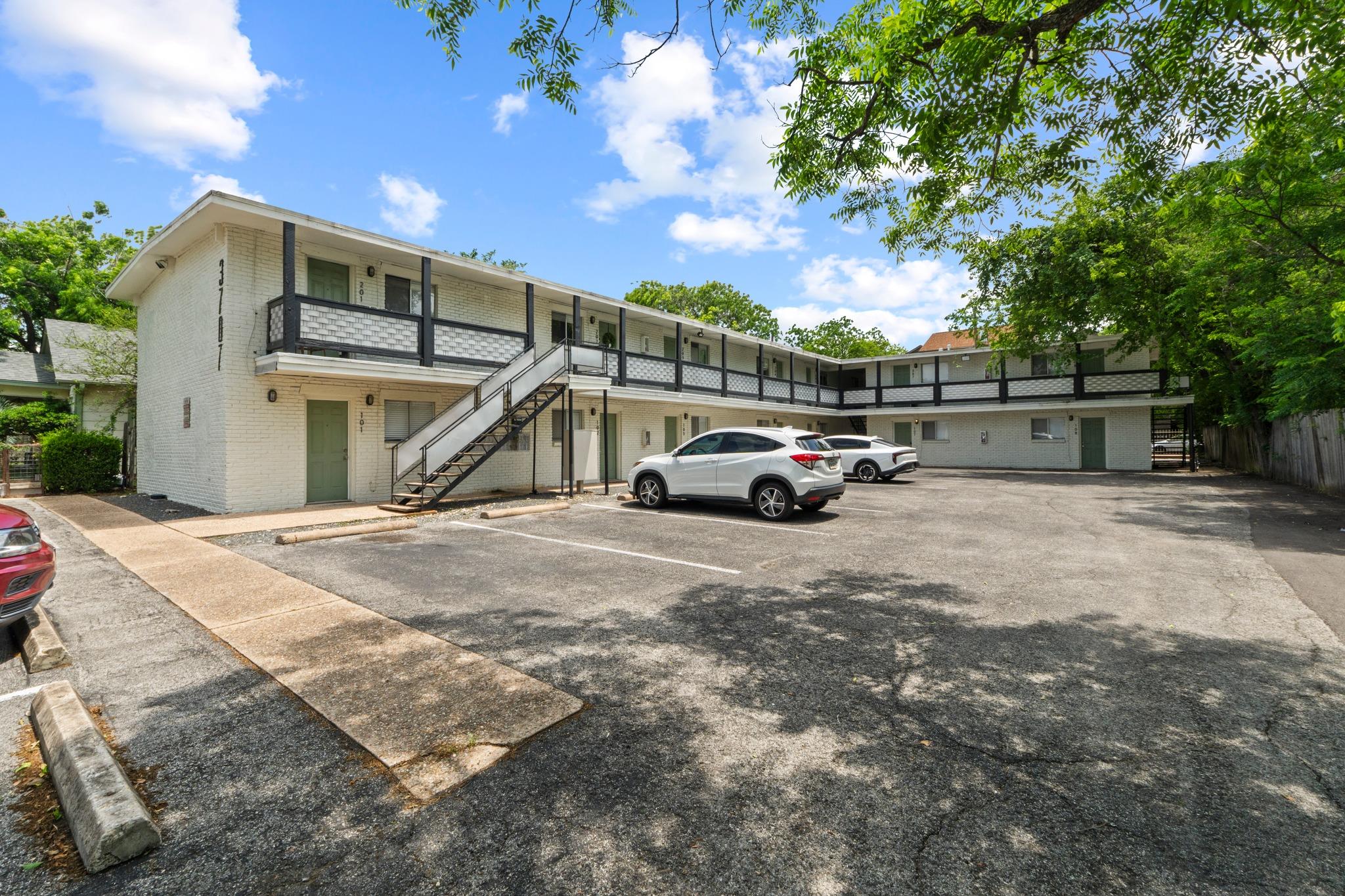 Two-story multi-unit structure featuring white br