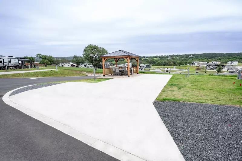 Spacious concrete pad featuring a wooden gazebo w
