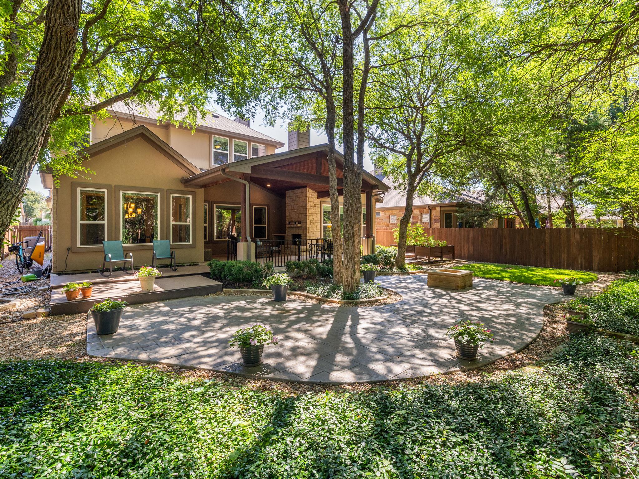 Backyard patio featuring a large circular paver a