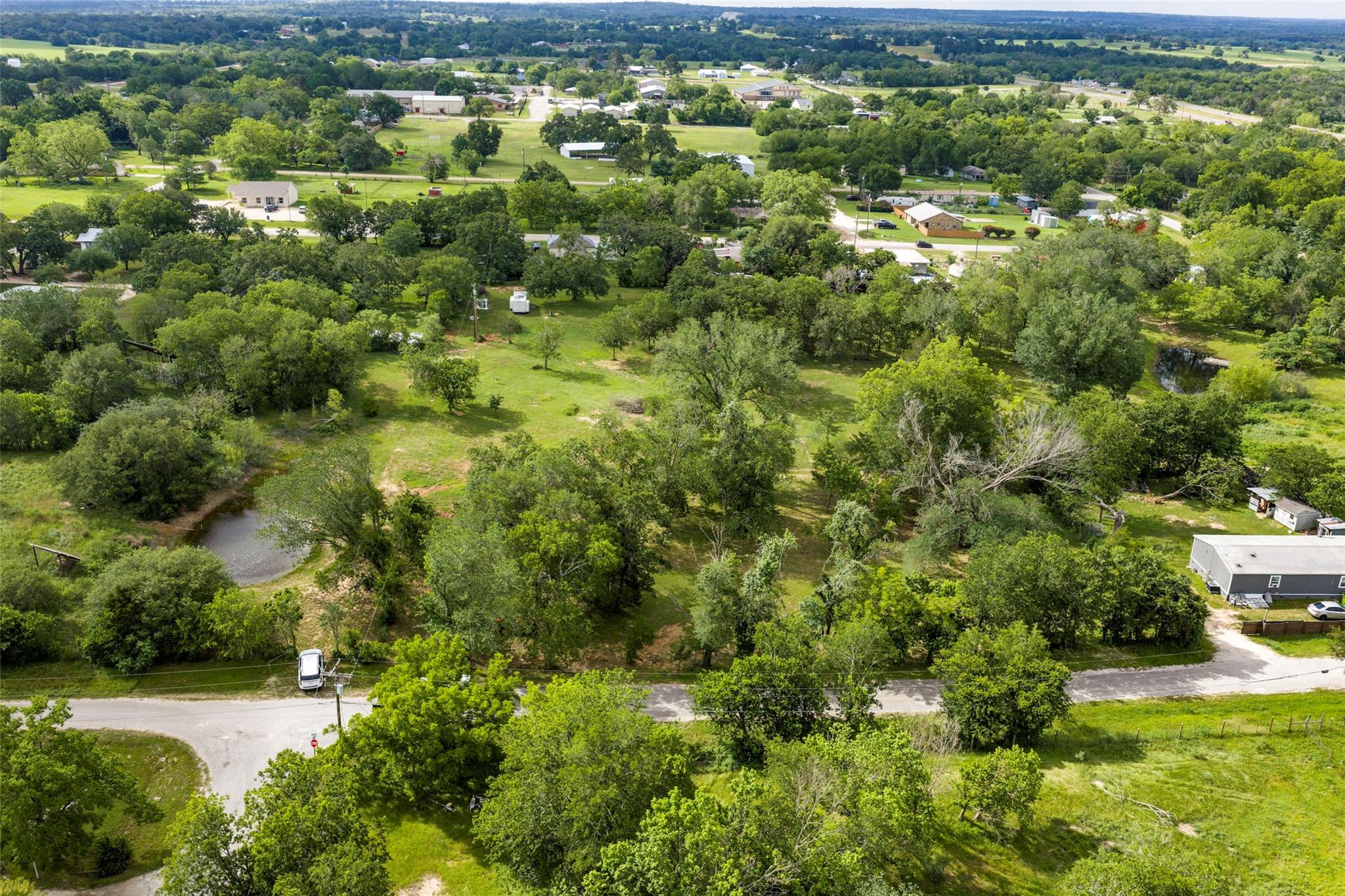 Expansive land featuring diverse tree coverage, o