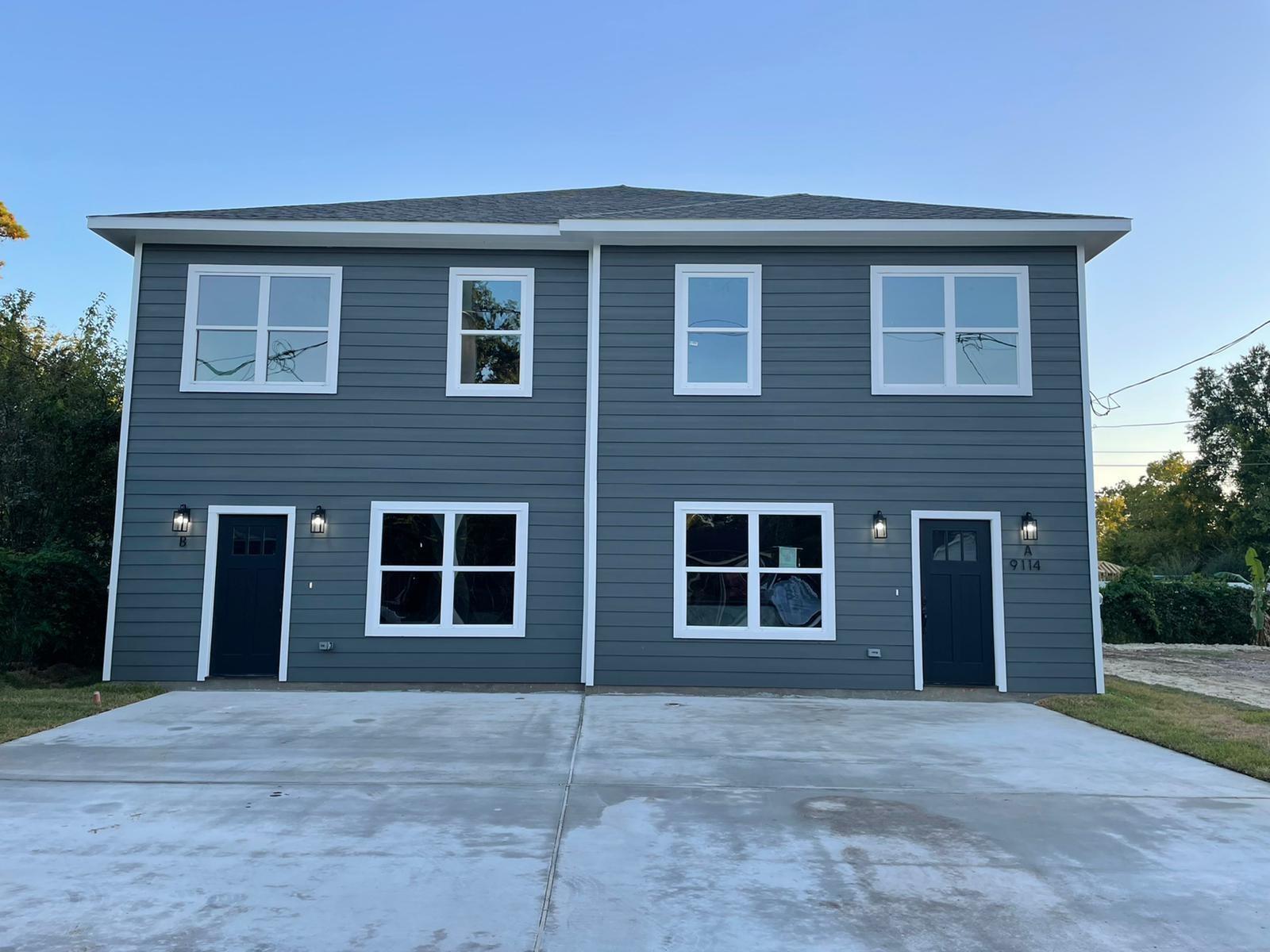 Modern duplex exterior featuring horizontal sidin