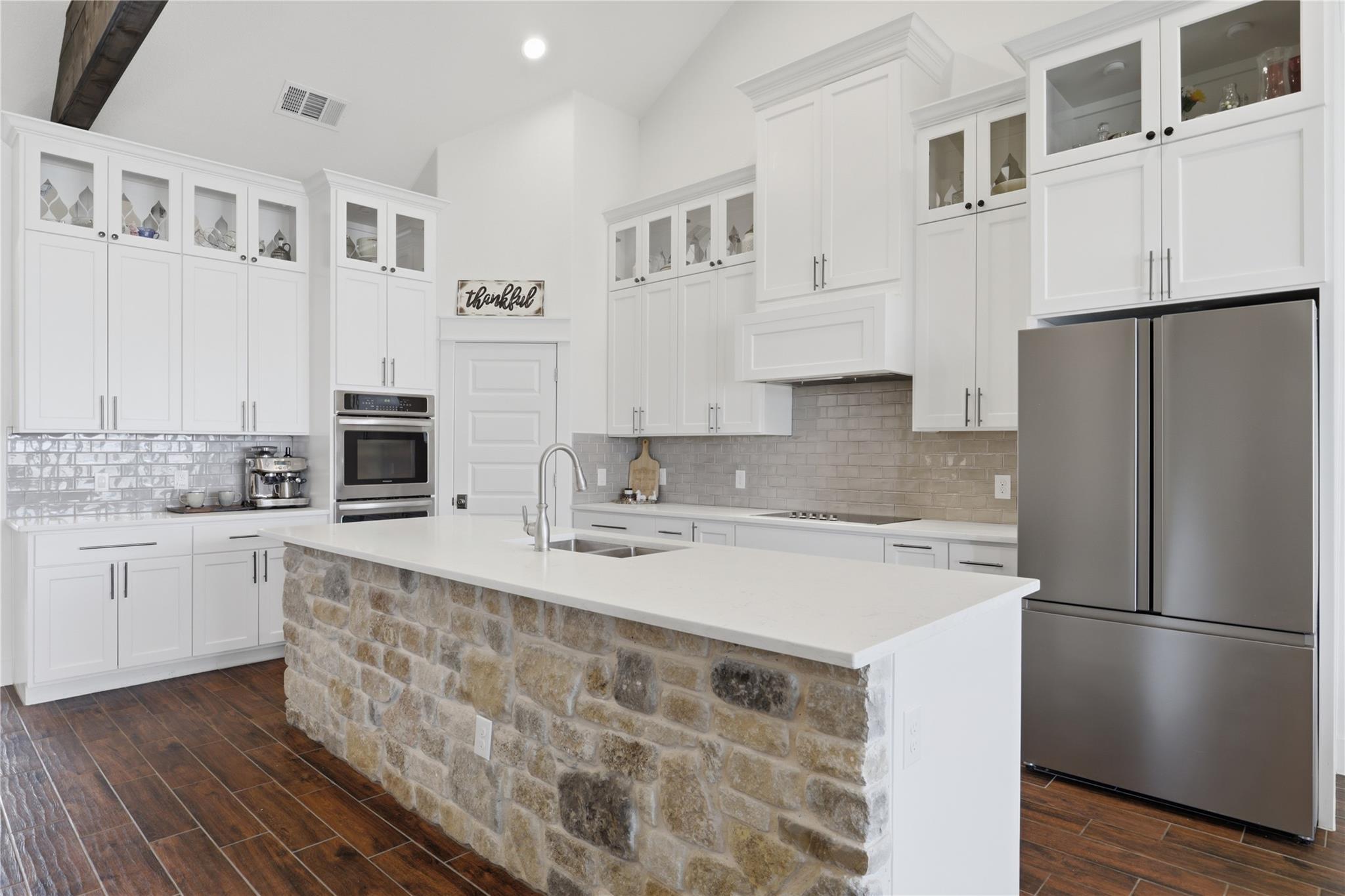Contemporary kitchen featuring a stone-clad islan