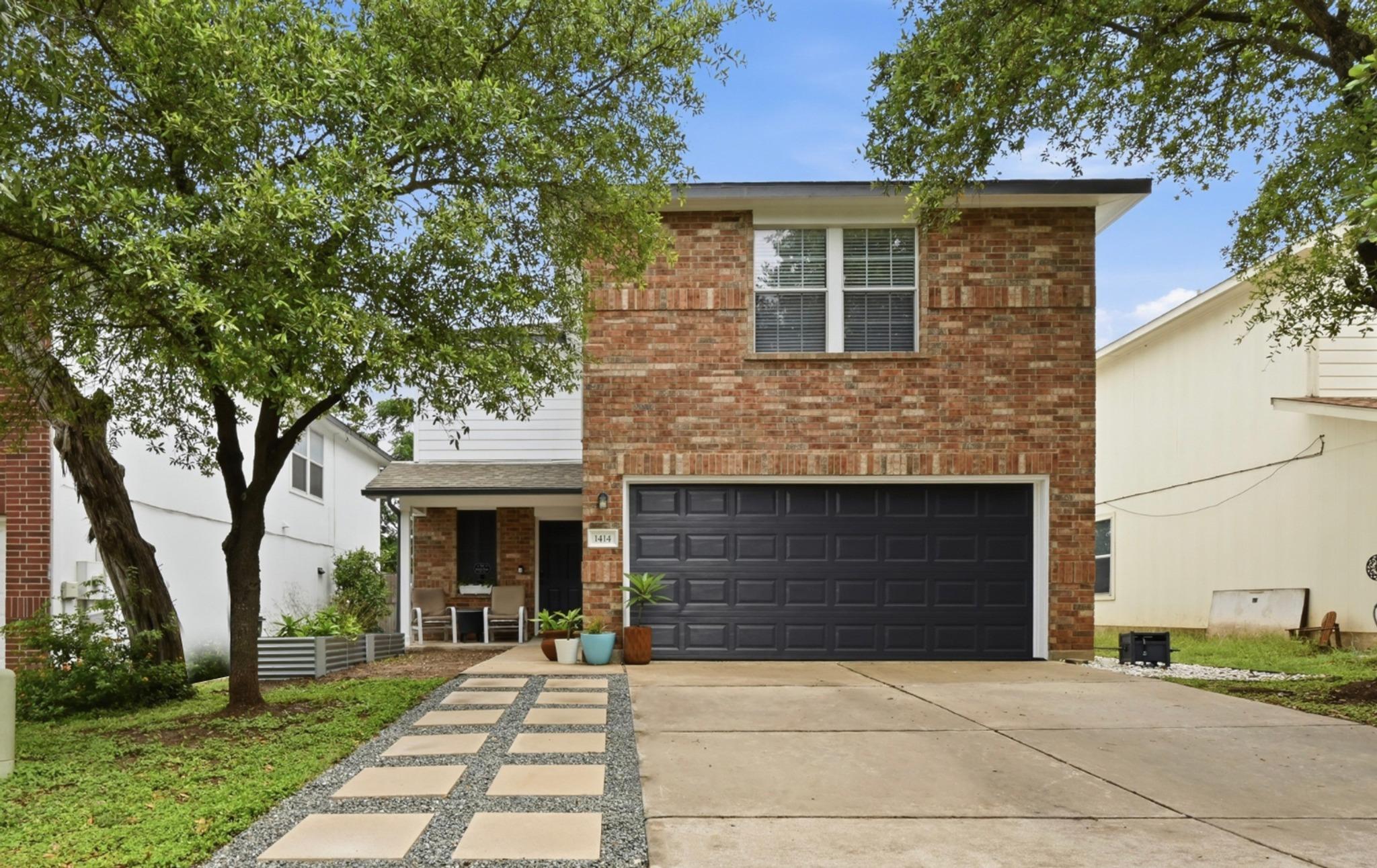 Brick facade home featuring a spacious driveway a