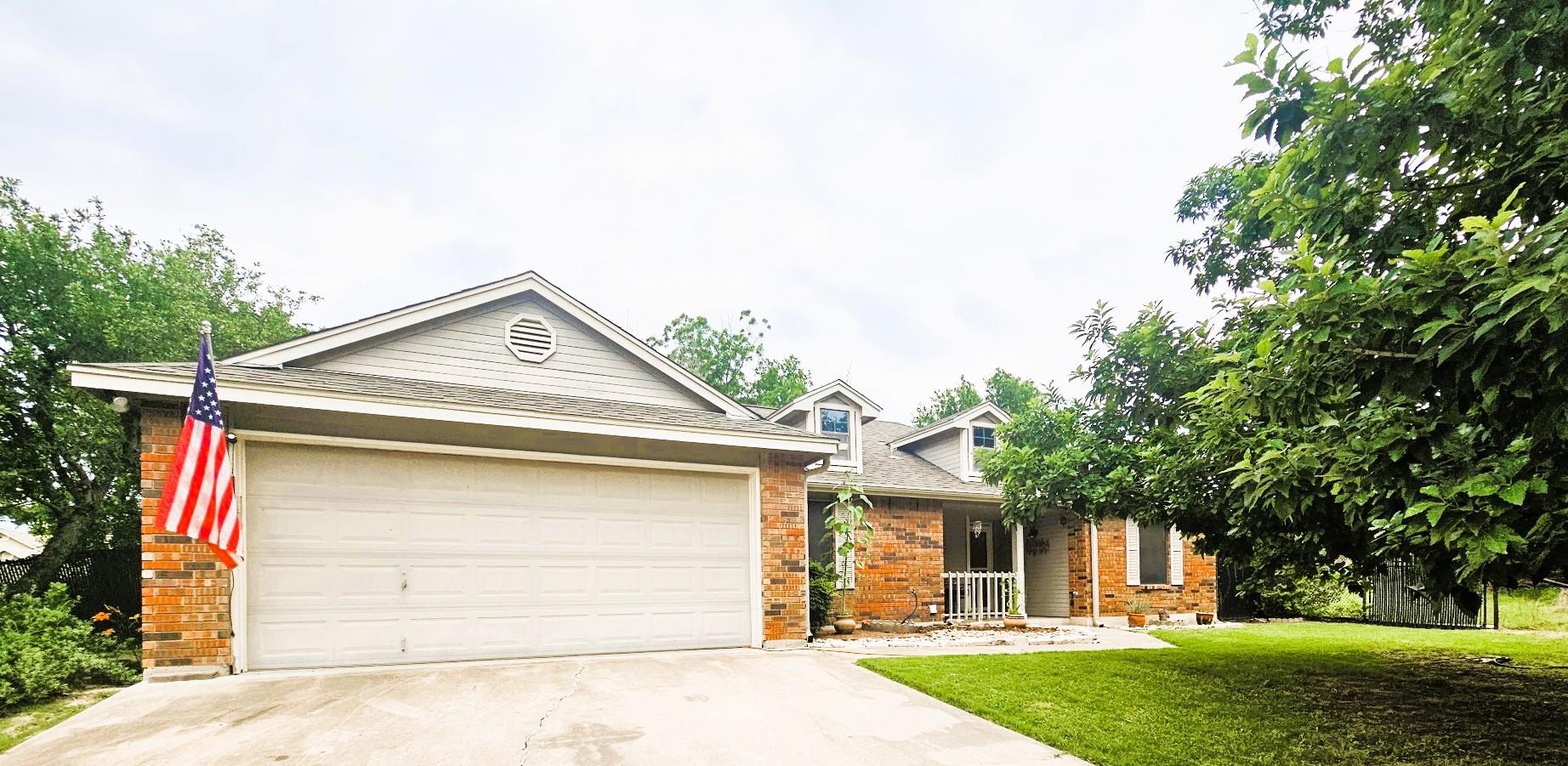 Brick facade home featuring a two-car garage, dor