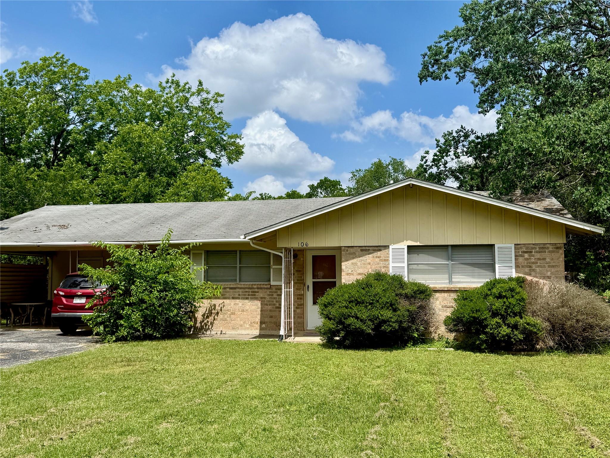 Brick exterior with gabled roofline and front ent
