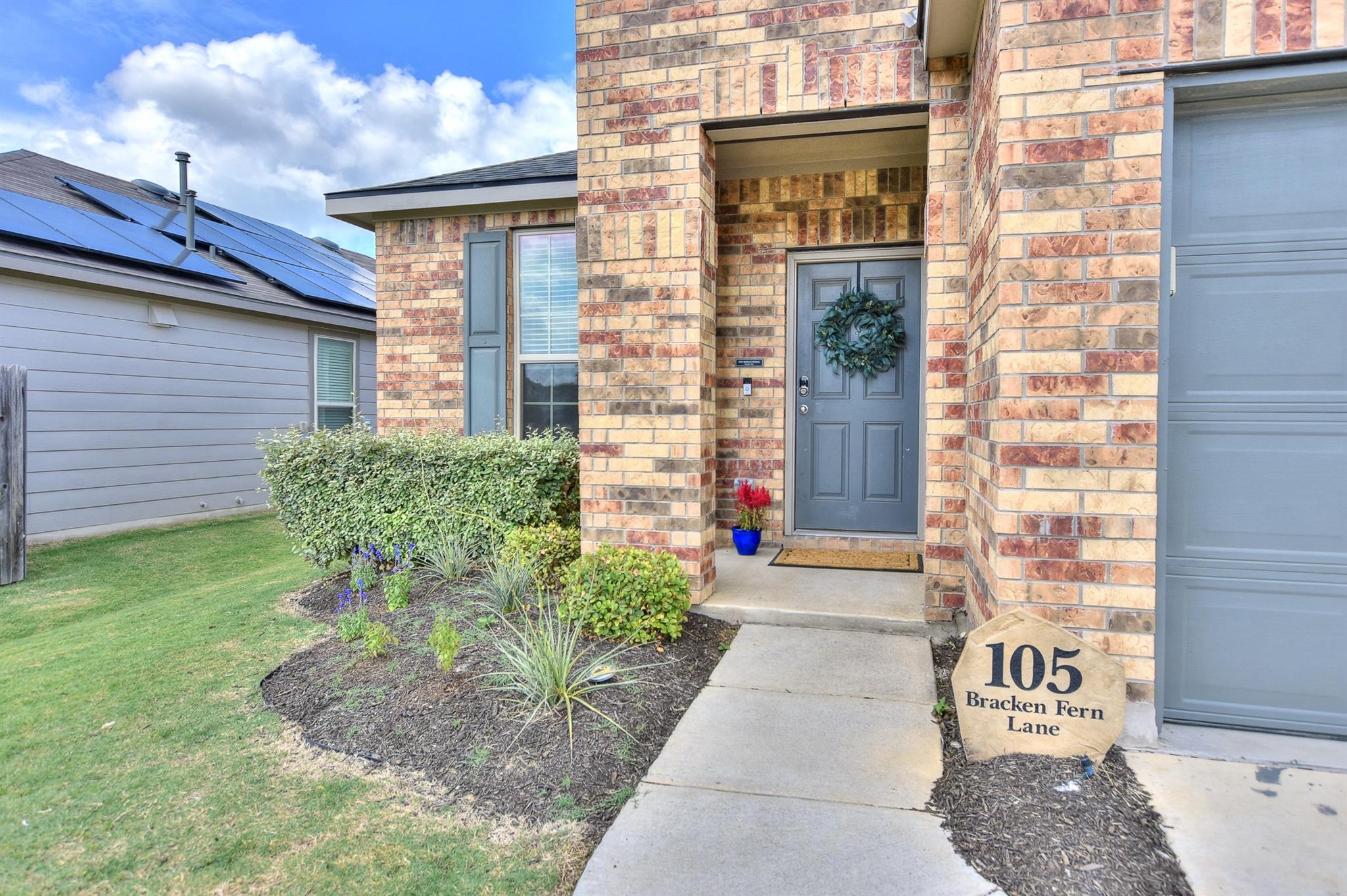Brick facade home featuring a paneled front door,