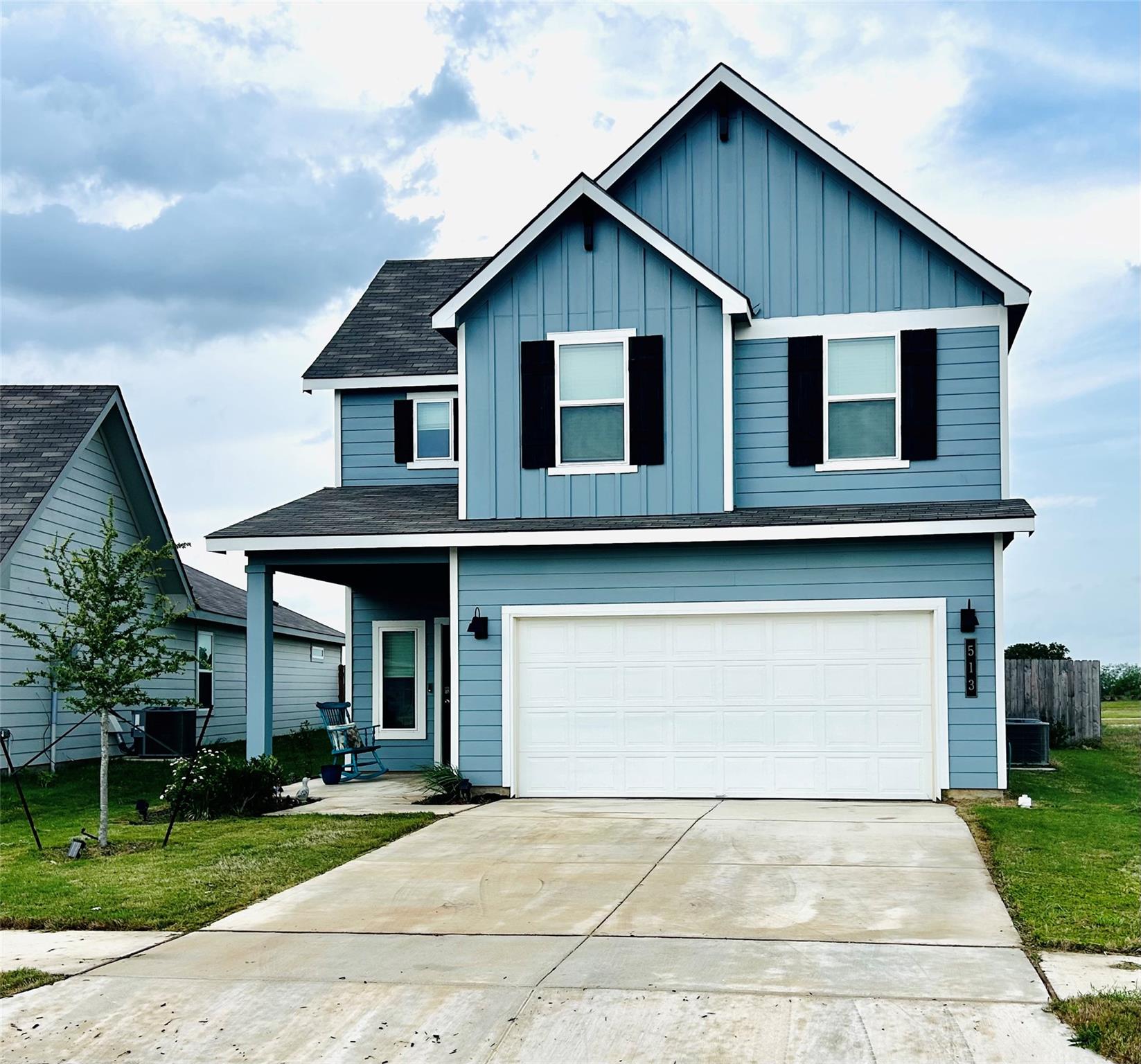 Two-story residence featuring blue horizontal sid