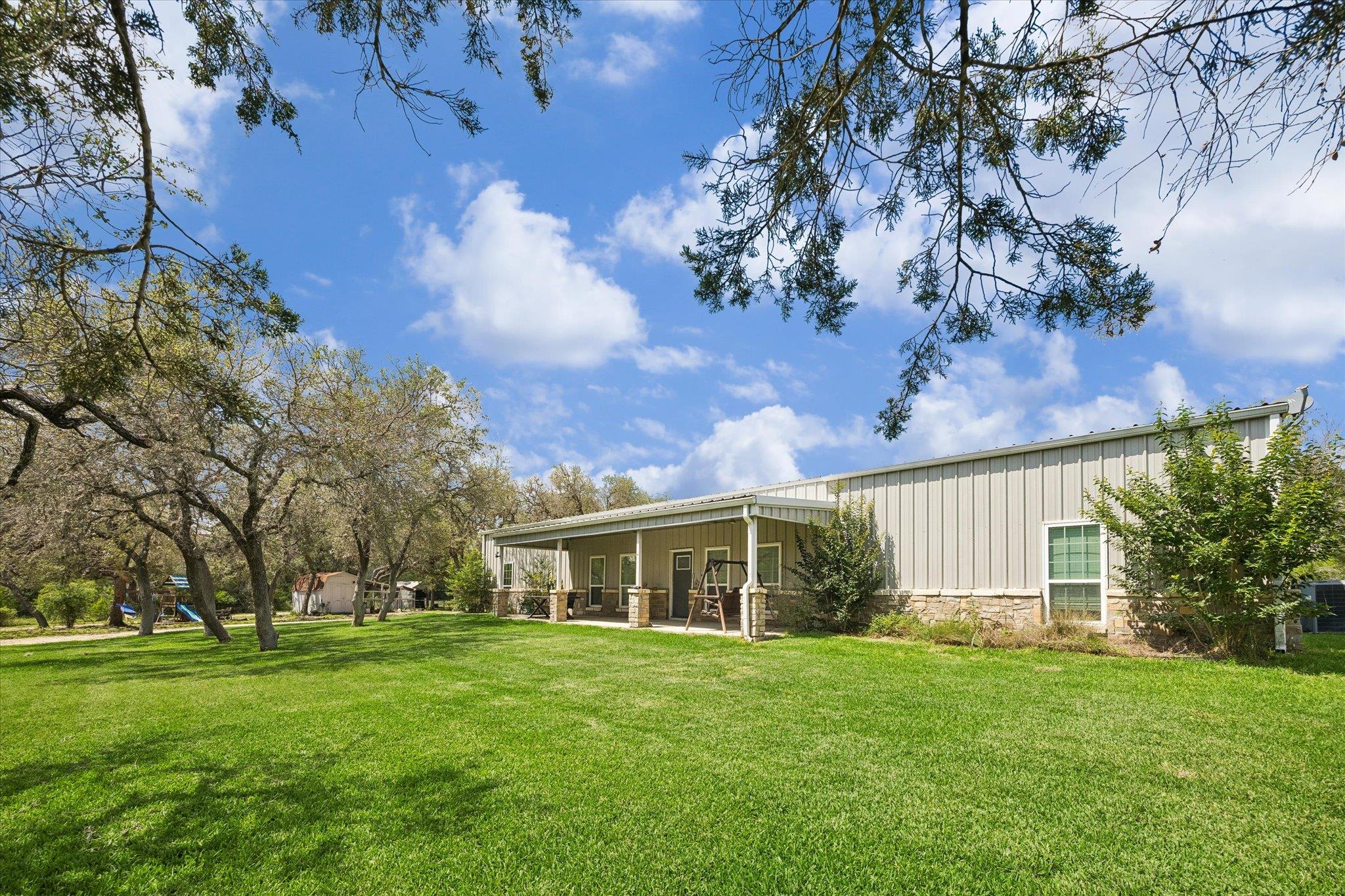 Expansive green lawn bordering a property with a 