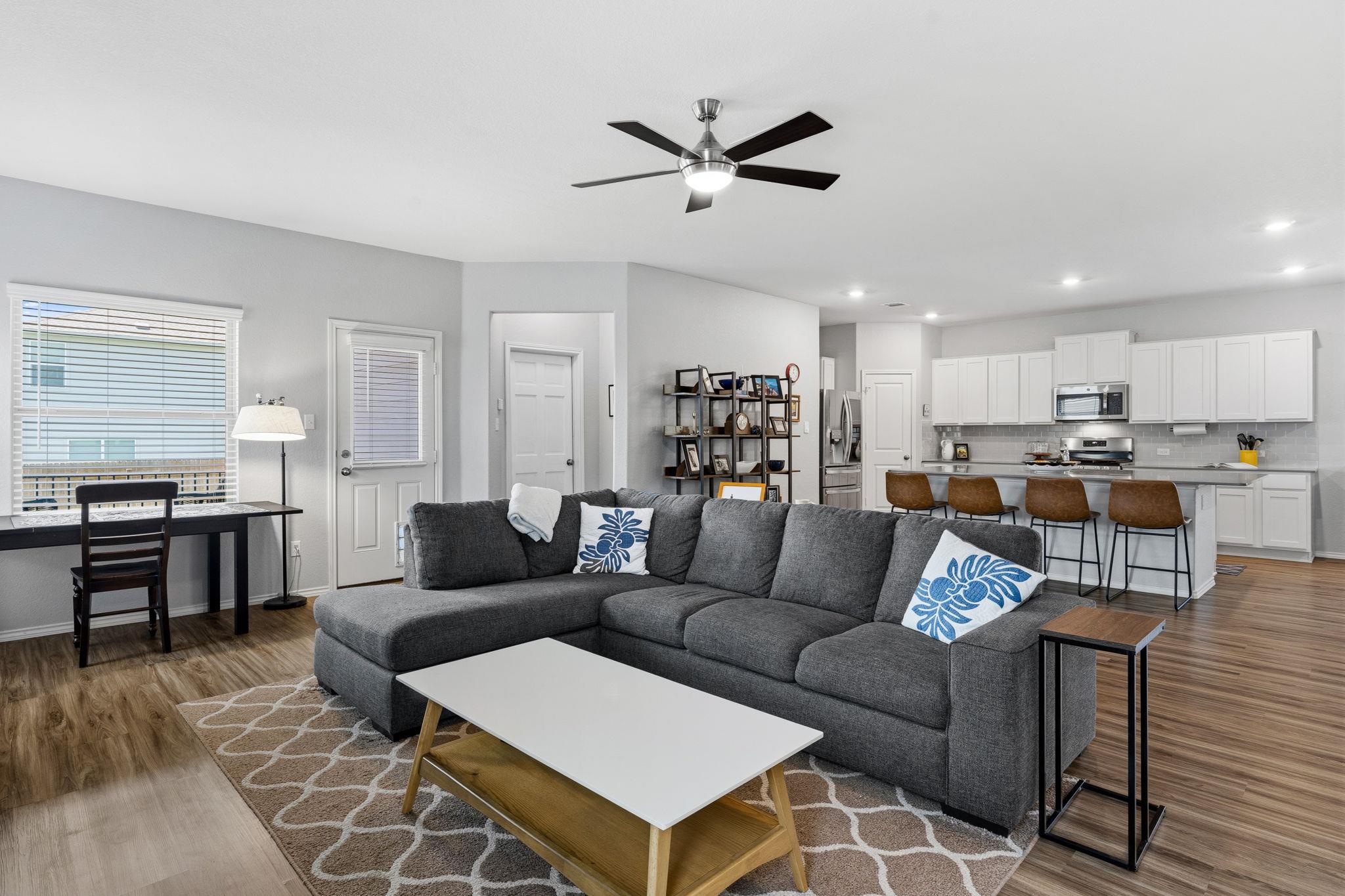 Open-concept living area featuring wood-finish fl