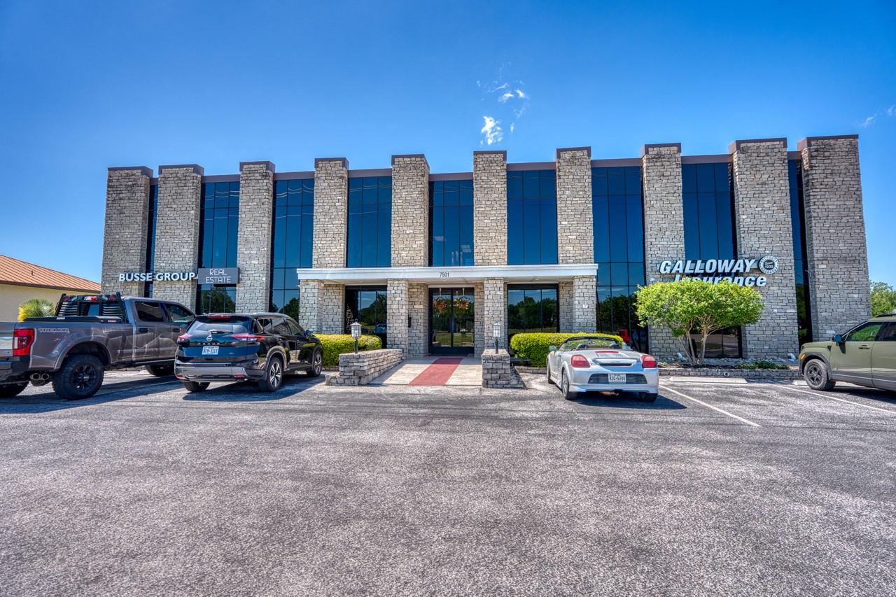 Commercial building with stone facade and dark-ti