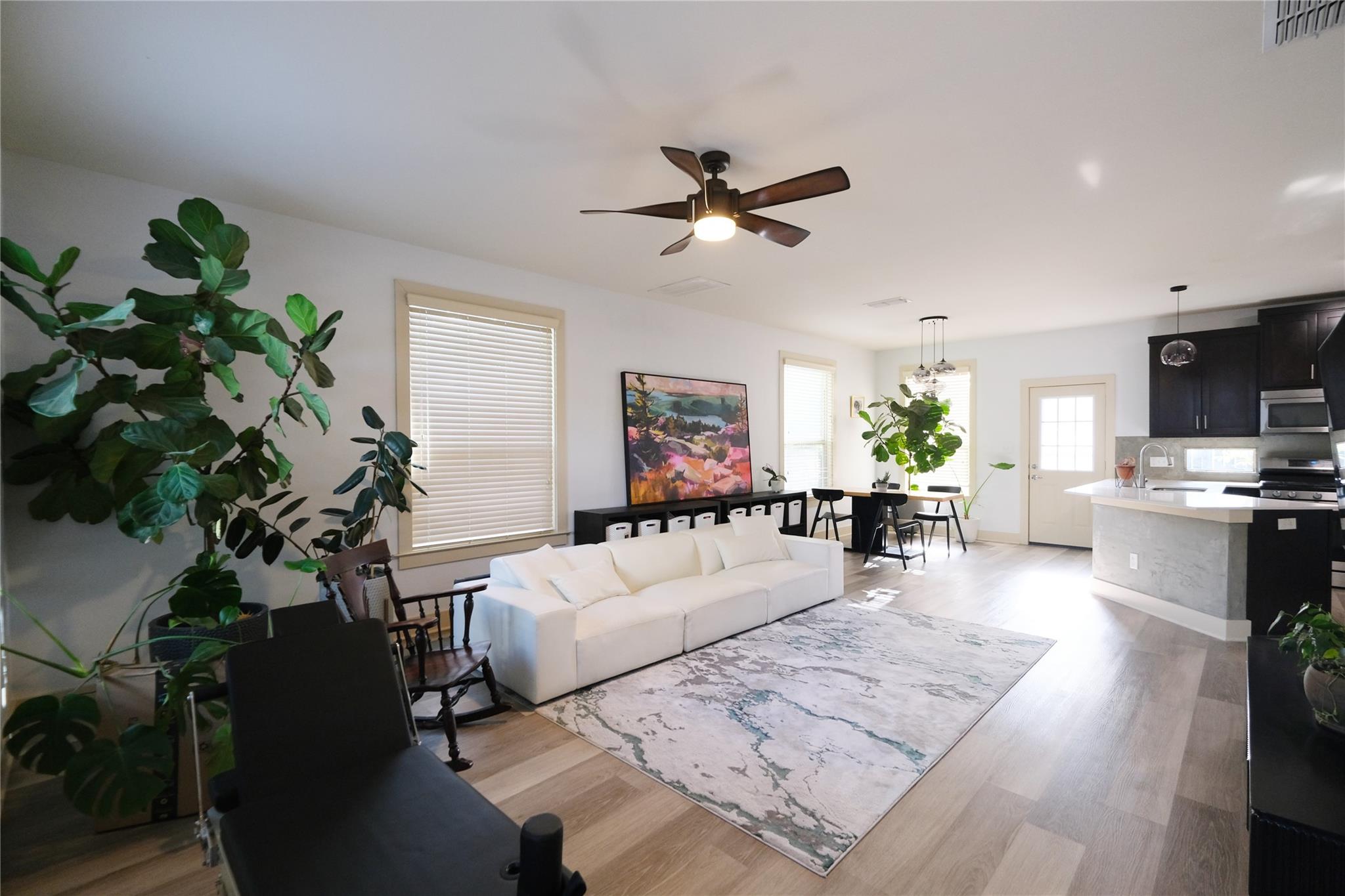 Open-concept living space with light wood-finish 
