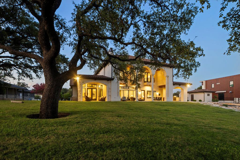Expansive rear yard featuring a manicured lawn, m