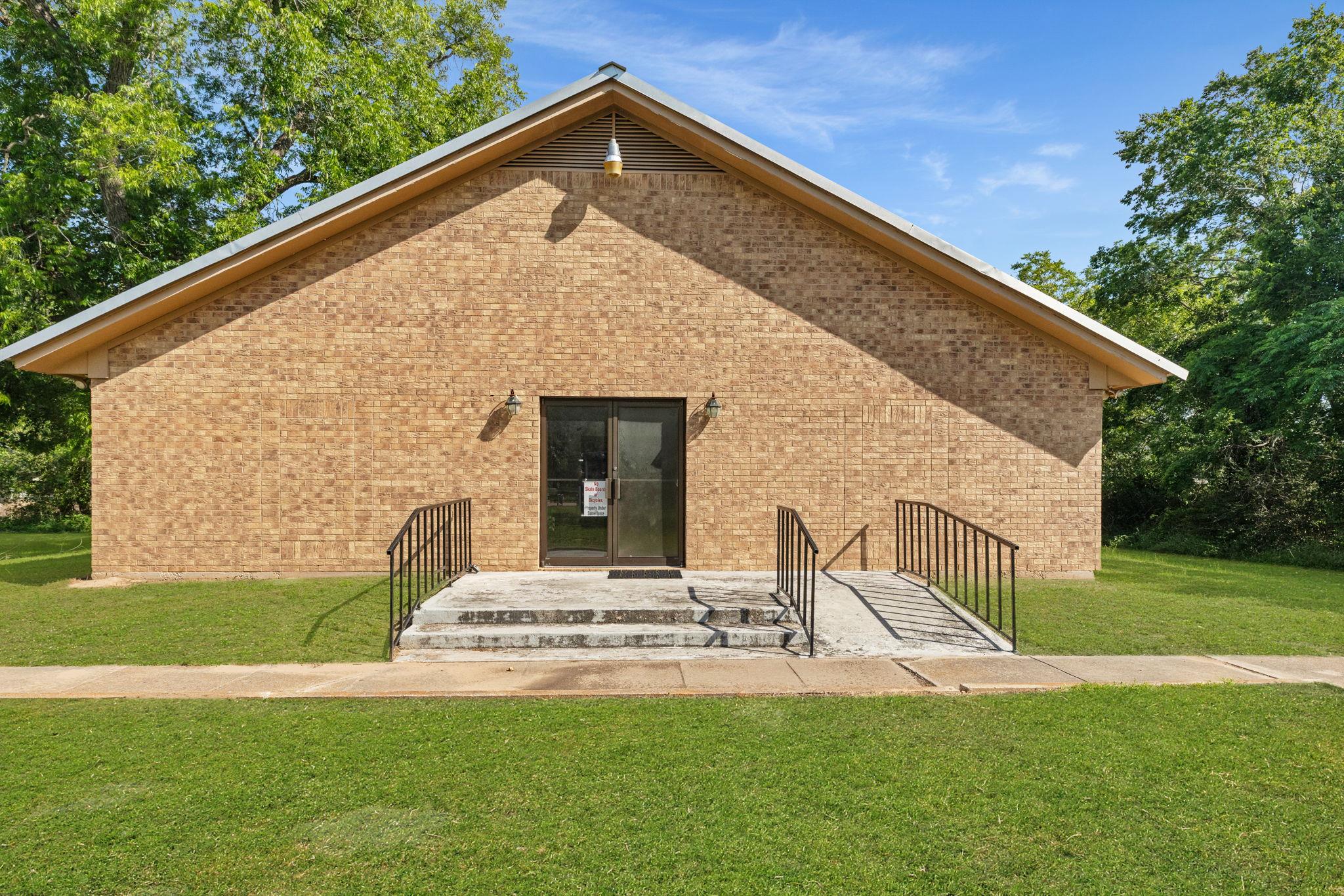 Brick exterior building with a pitched roof, feat