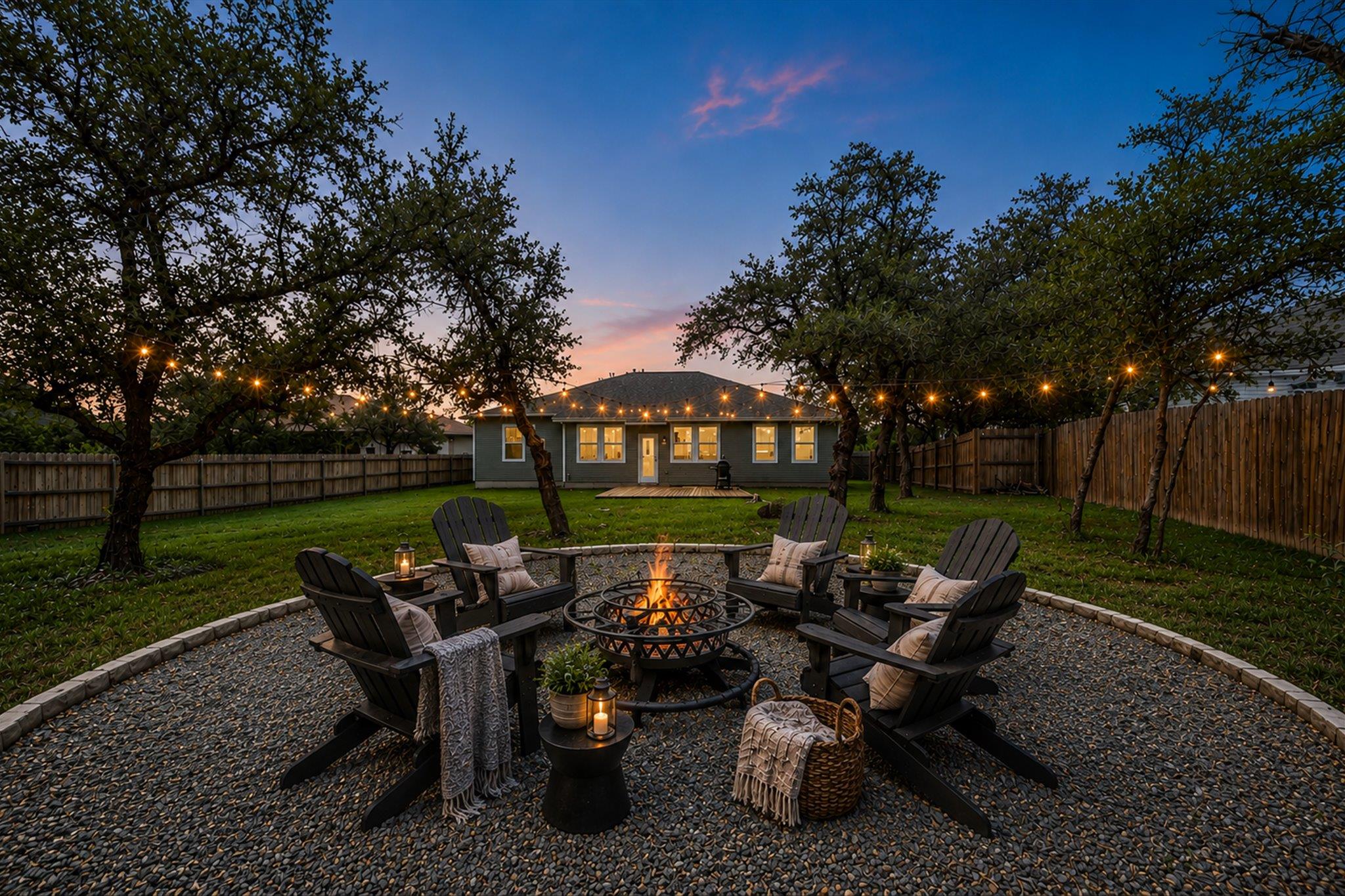 Expansive backyard featuring a circular gravel pa