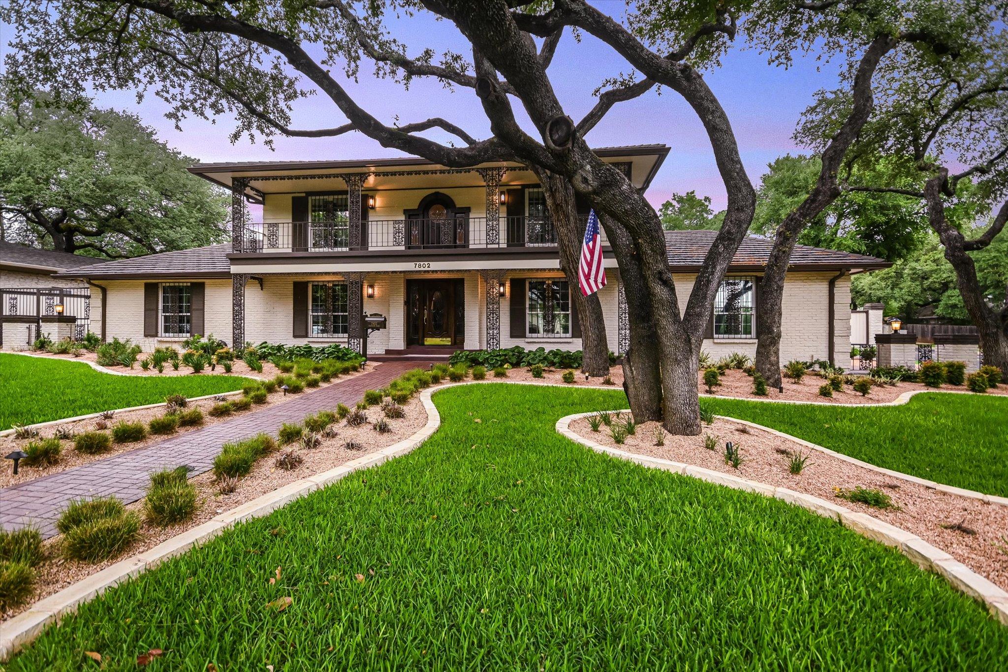 Two-story residence featuring a covered balcony, 