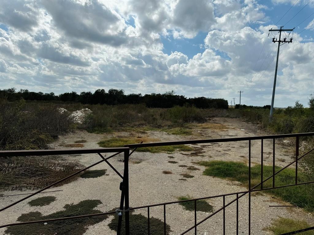 Gated raw land parcel featuring natural terrain a