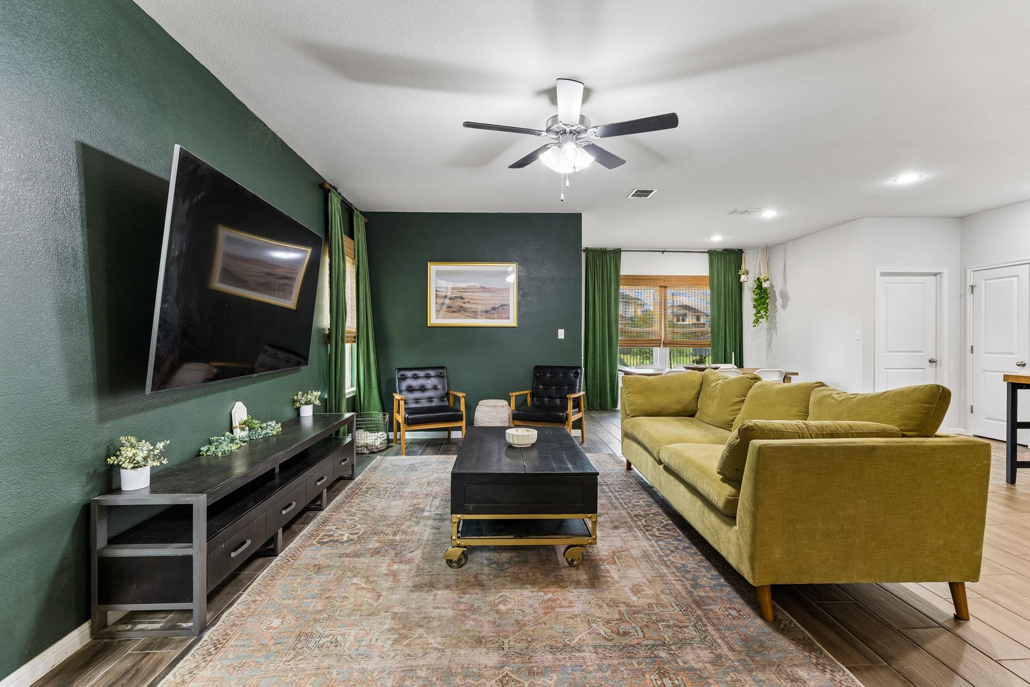 Spacious living area featuring a dark green accen