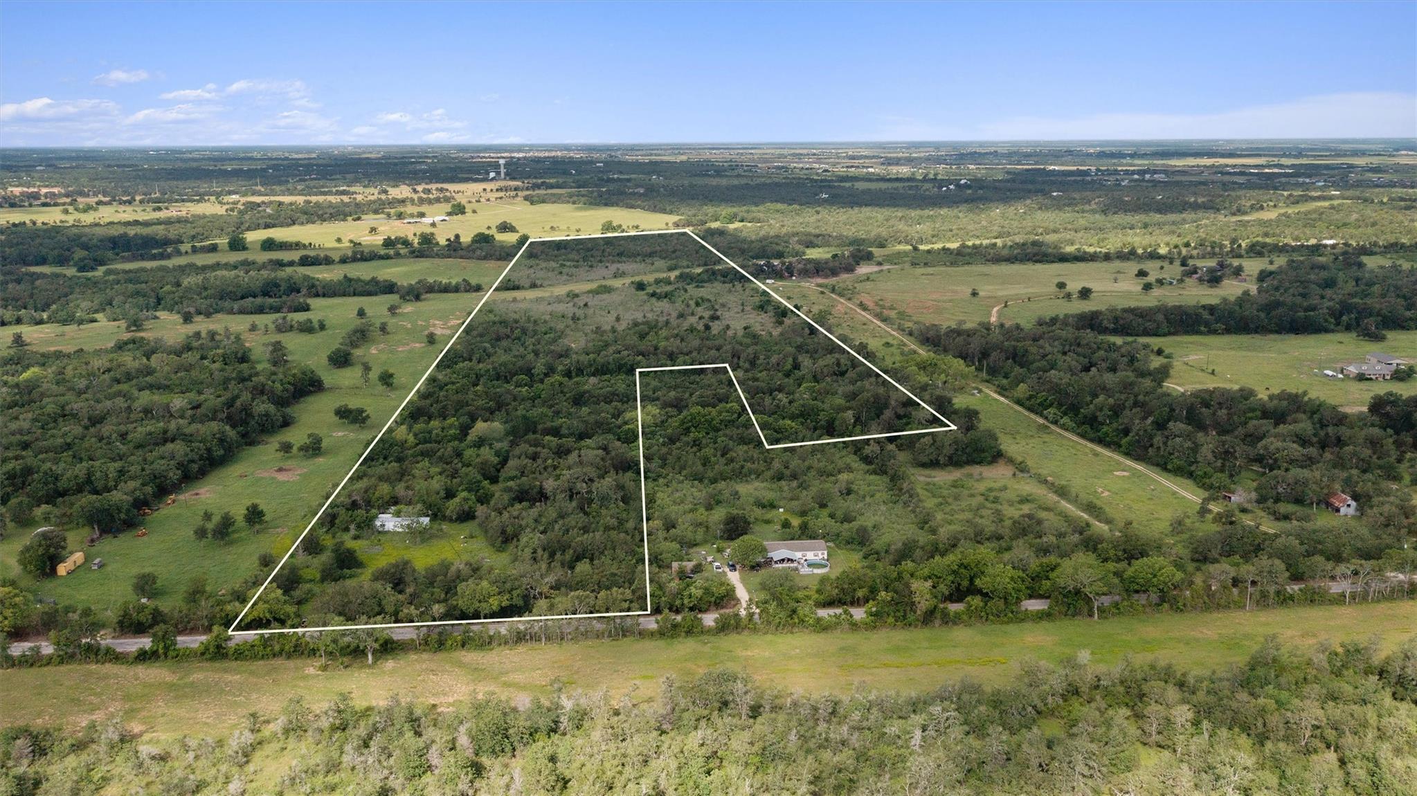 Expansive land parcel featuring a mix of mature t