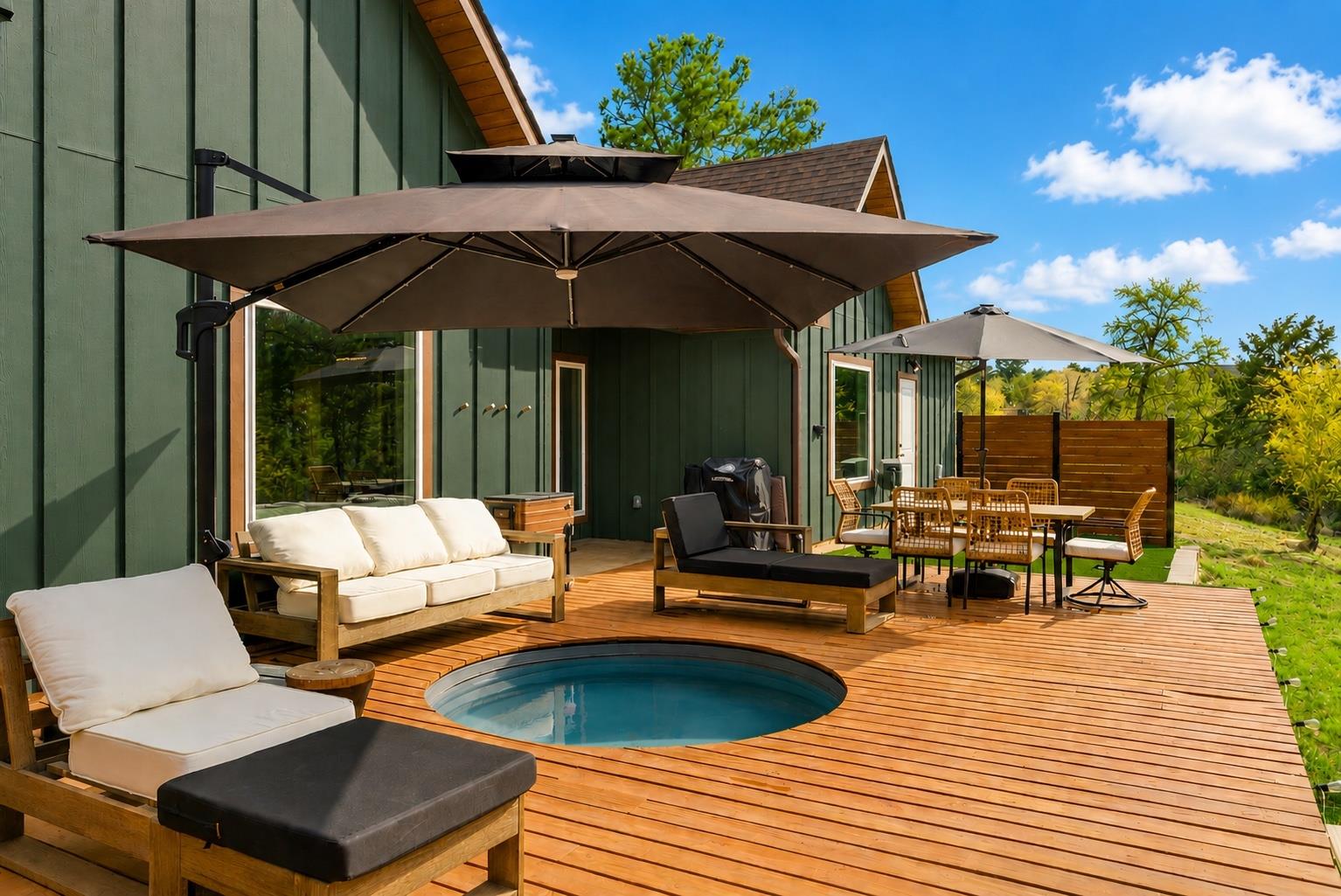 An inviting wood deck features an in-ground spa a