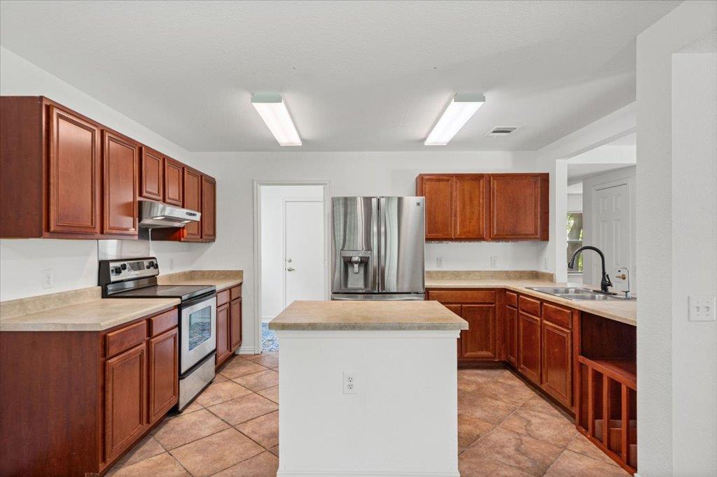 A well-equipped kitchen features durable tile flo
