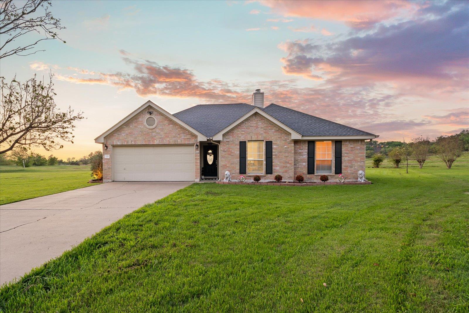 Brick exterior residence featuring a front-facing