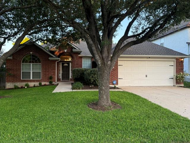 Red brick exterior with a dark shingle roof, arch
