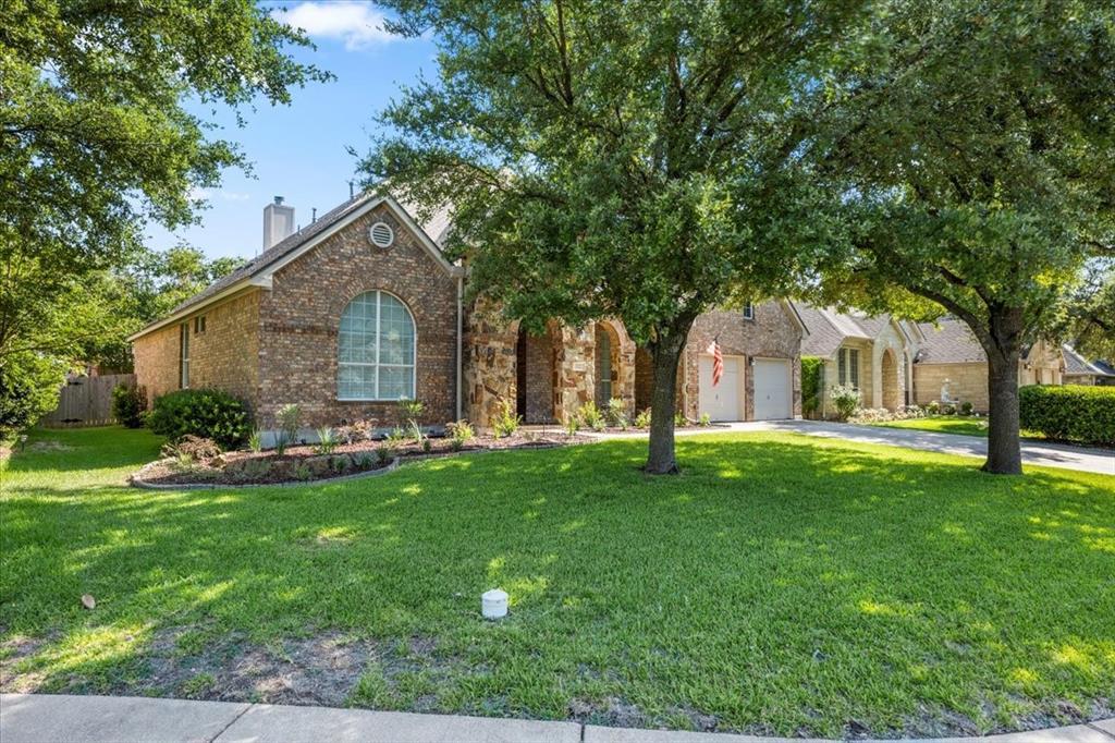 Brick and stone exterior featuring an arched wind