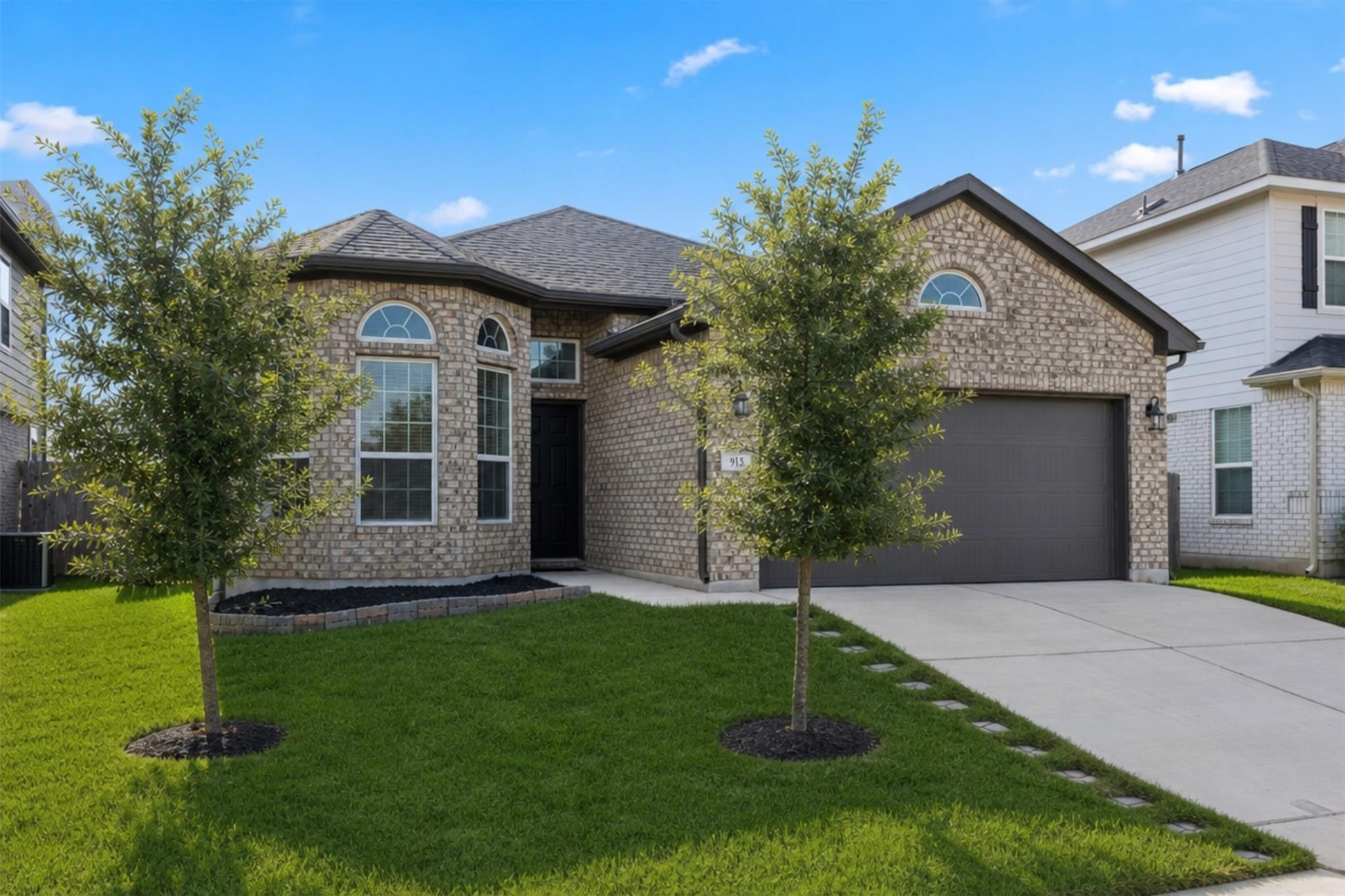 A classic brick exterior with an attached garage 