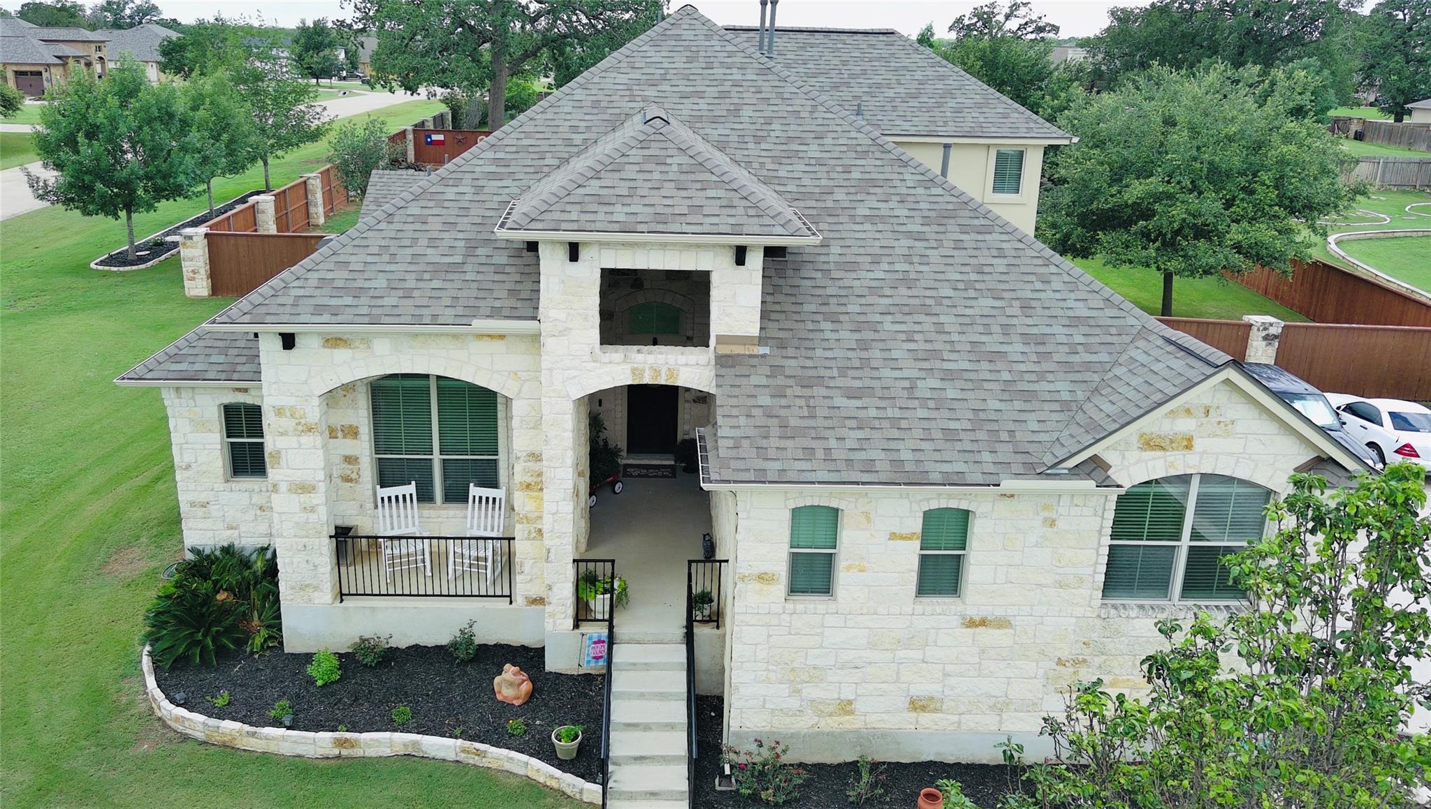 Two-story residence featuring a stone and stucco 