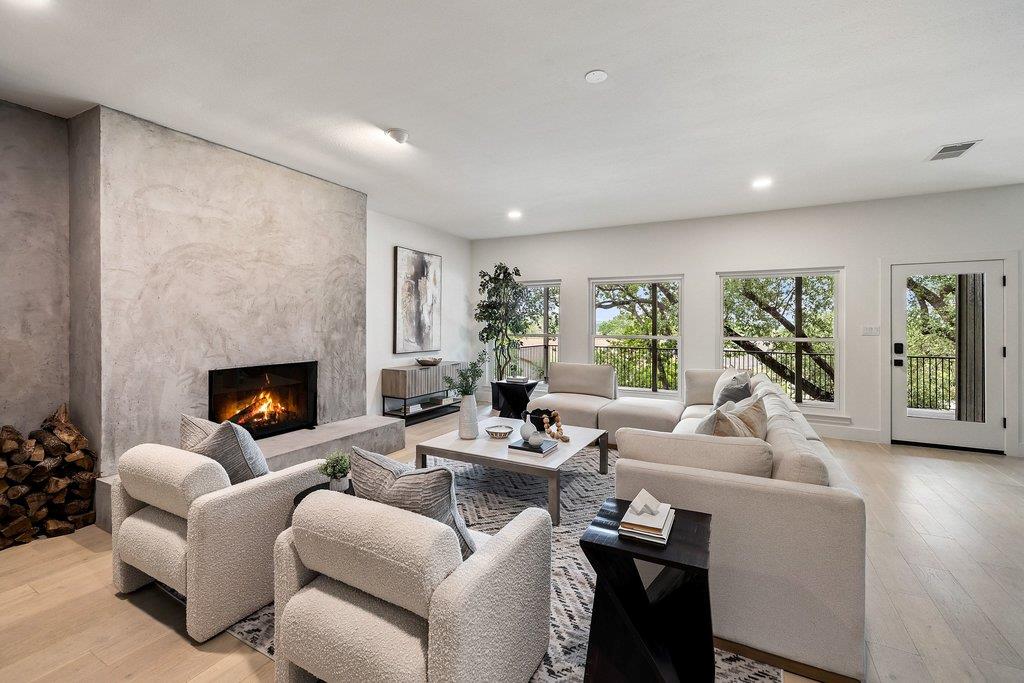 Spacious living area featuring a prominent firepl