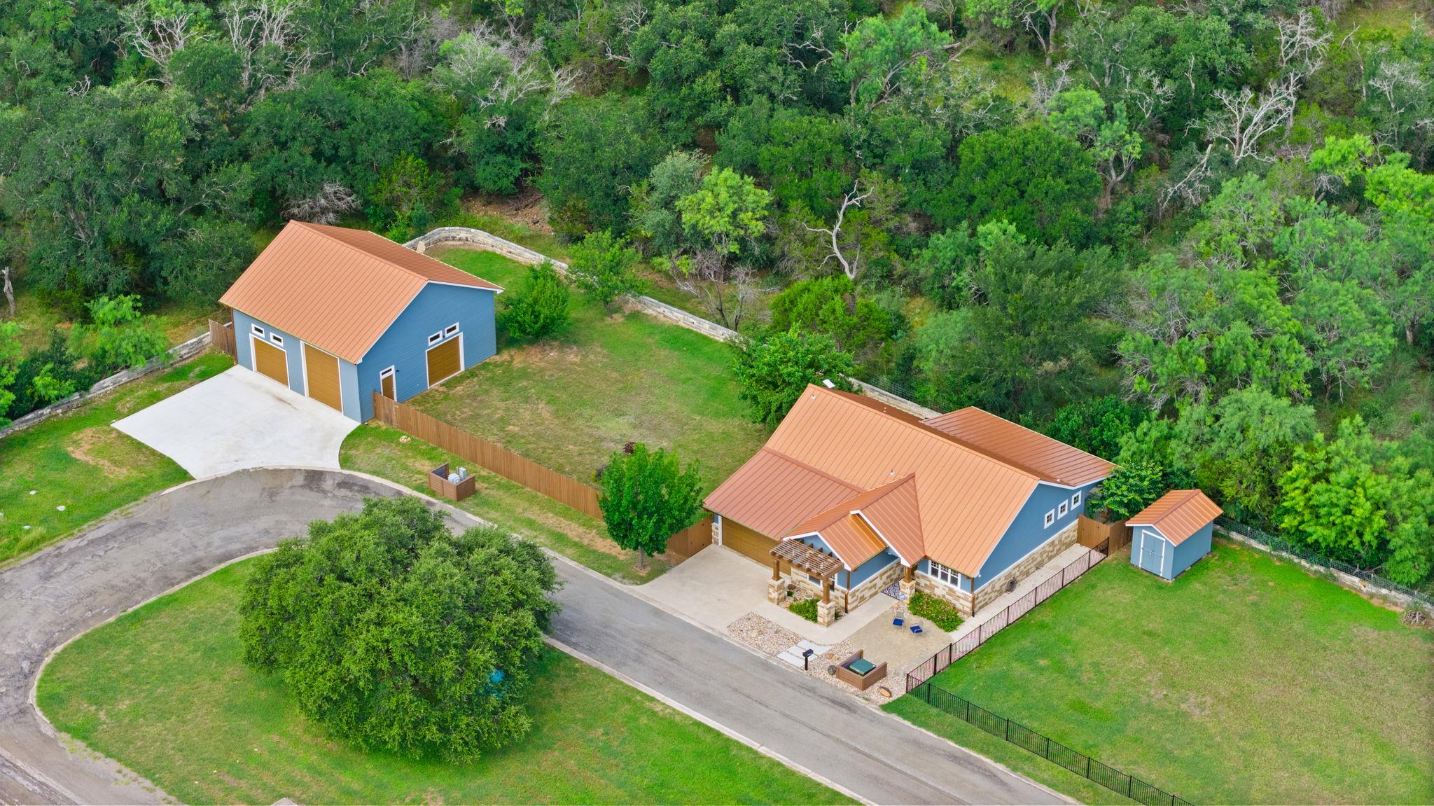 An aerial view showcases a vibrant blue residence