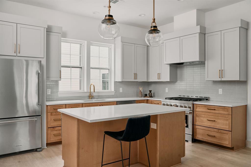 Modern kitchen featuring a light wood-finish isla