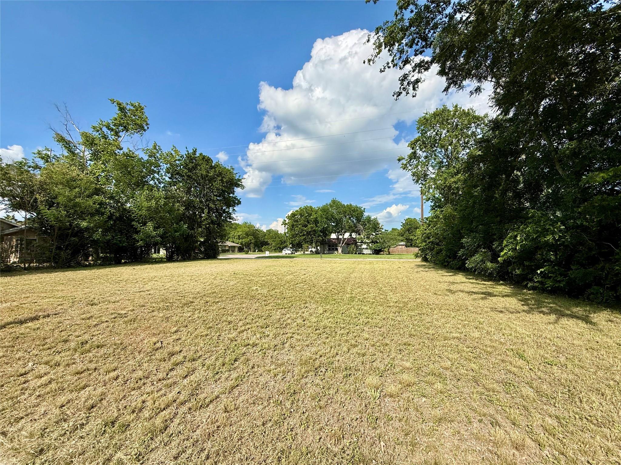 Expansive residential lot featuring a level, gras